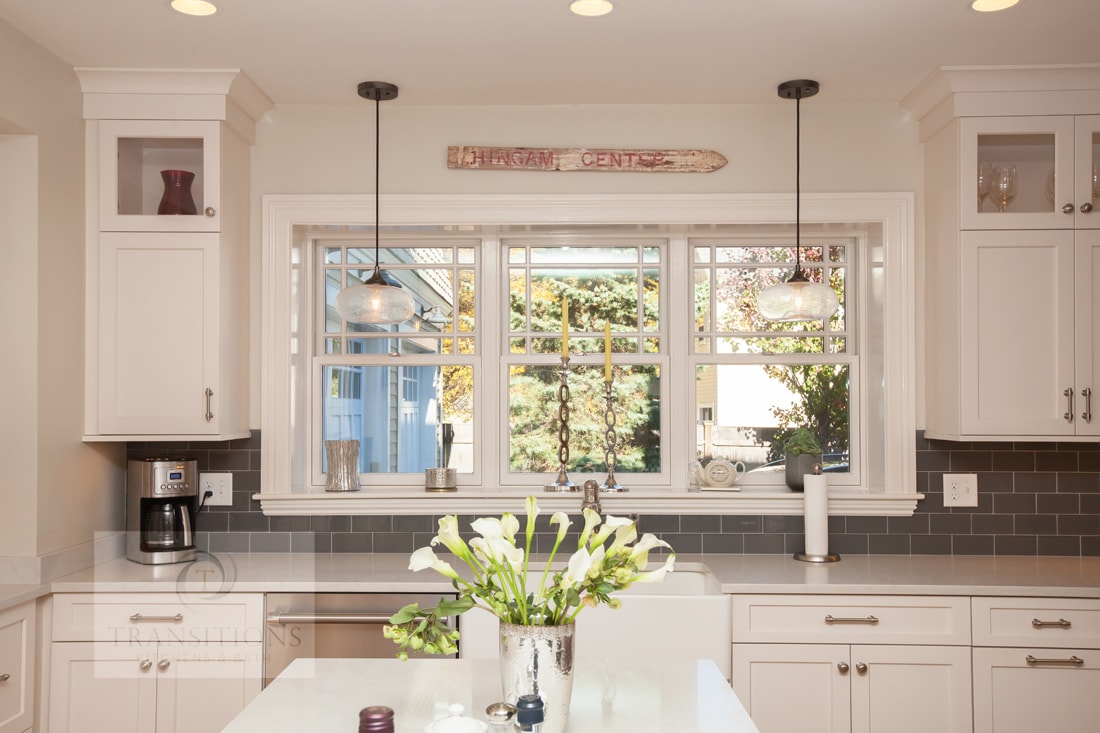 Custom shelves breaking up the cabinetry in the Hingham kitchen