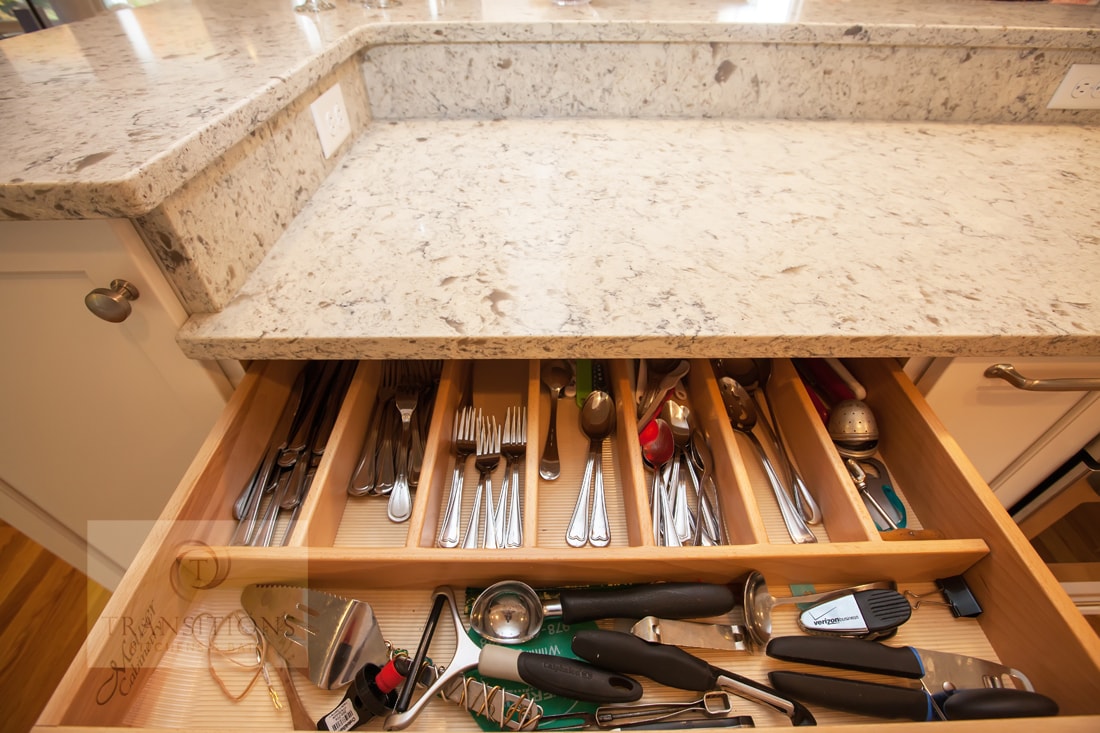 Wide view of the Cohasset kitchen showing the bi-level island and perimeter storage