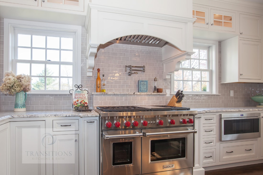 Gray island with seating and built-in storage in the Norwell kitchen