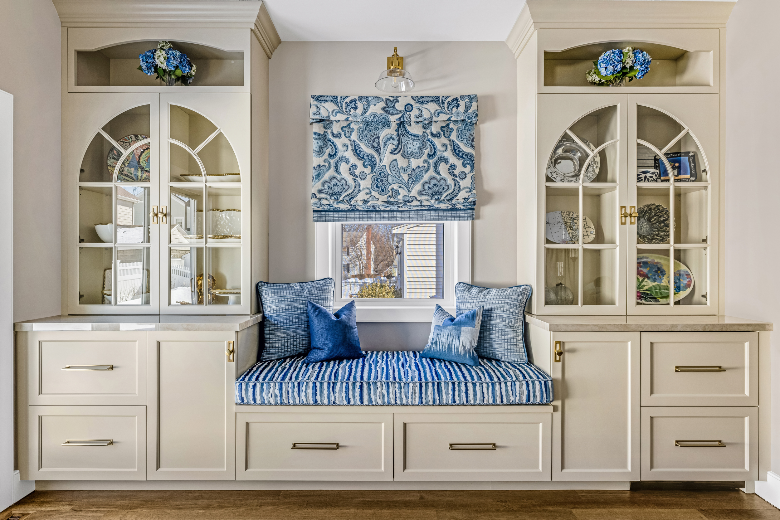 Mudroom with Tedd Wood cabinetry, bench seating, and Antigua Deco floor tile