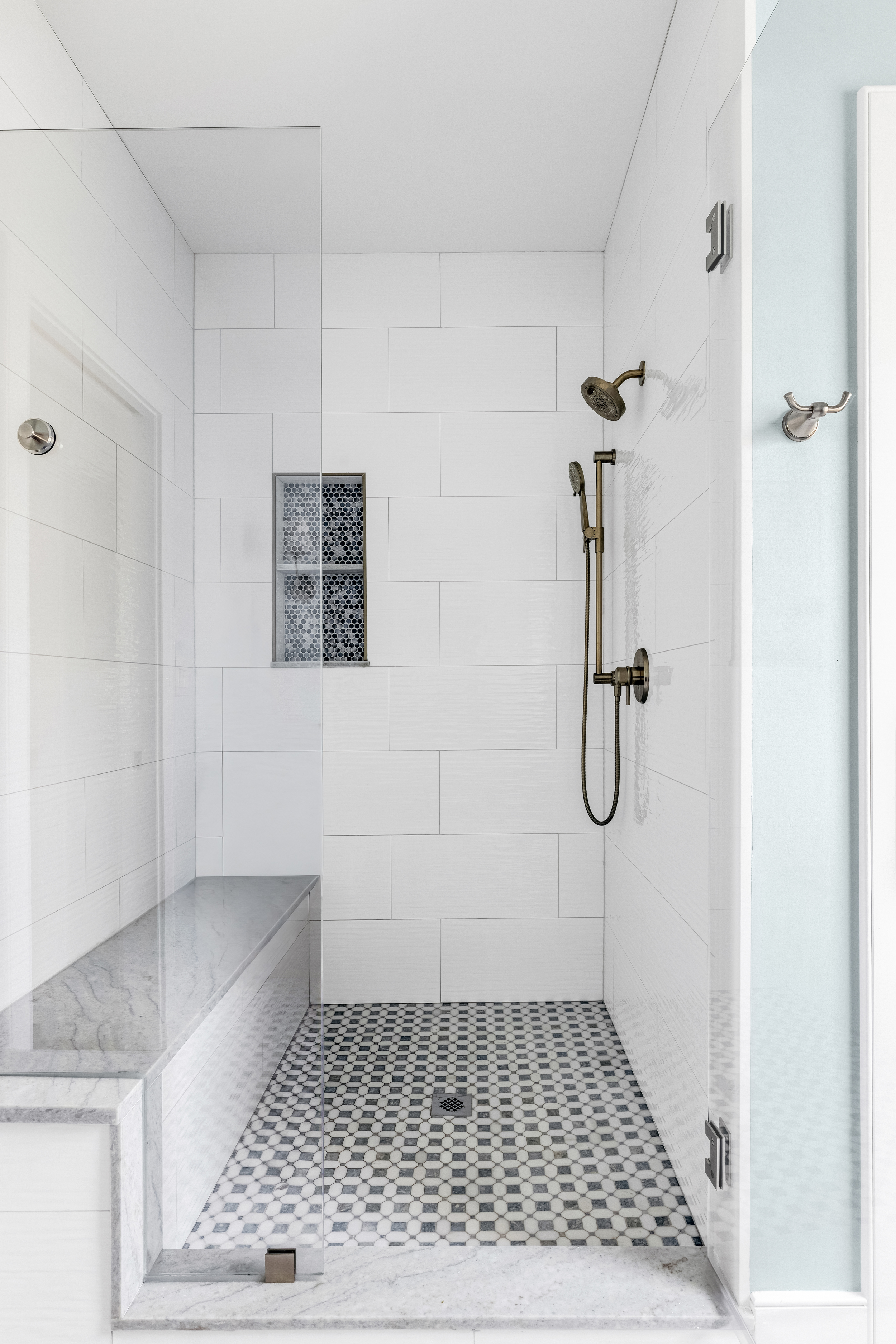 Marble countertop and brushed nickel fixtures in the primary bath