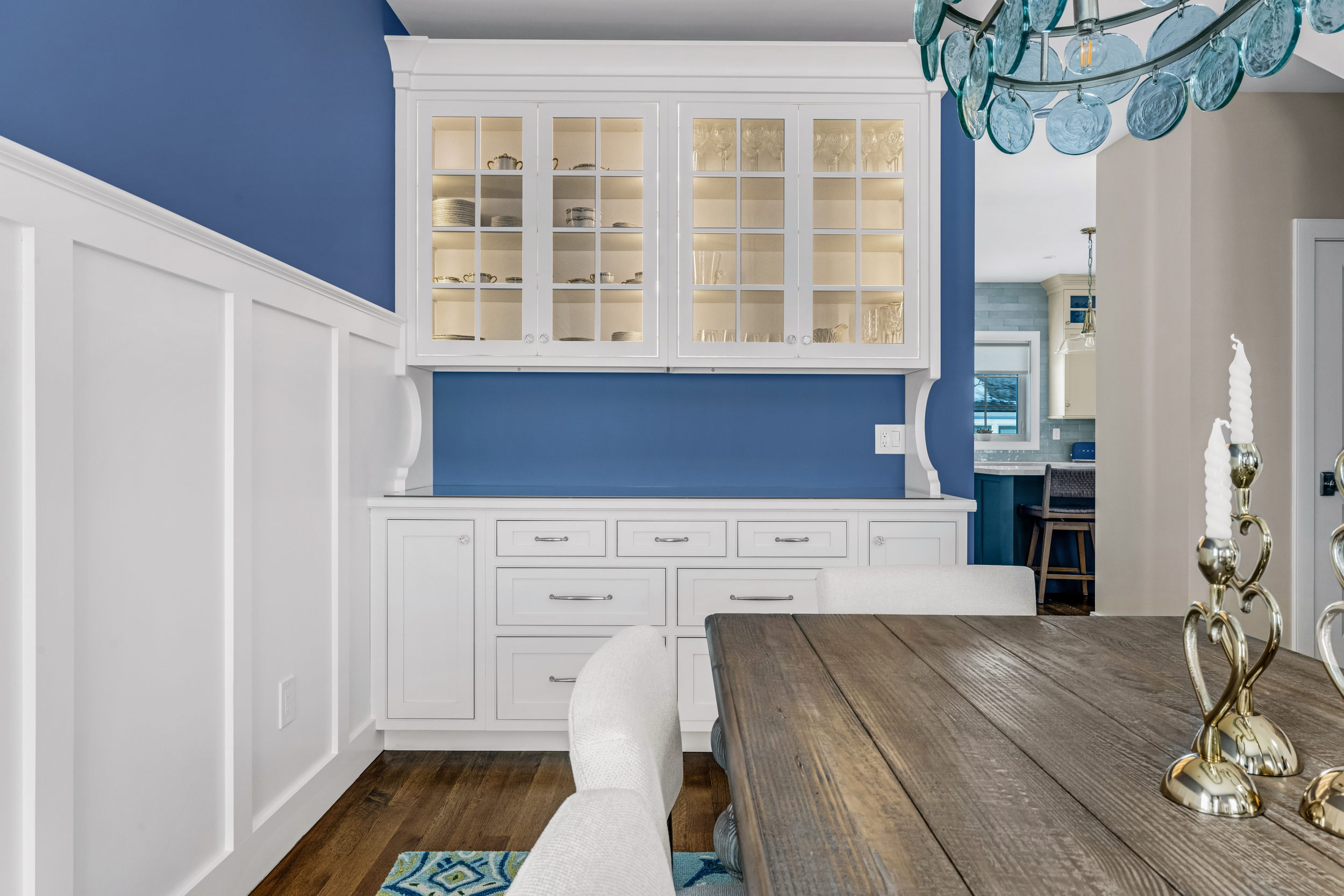 Built-in dining hutch in Mouser Divinity finish with glass-front cabinetry