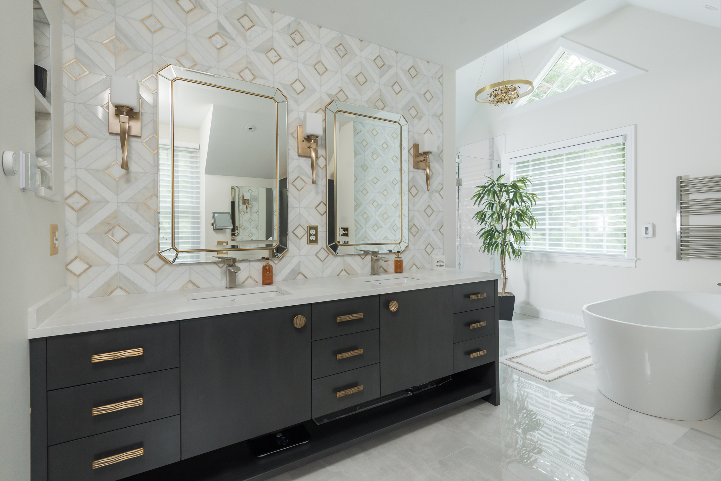 Refined Norwell primary bathroom with cobblestone grey vanity and brass accents
