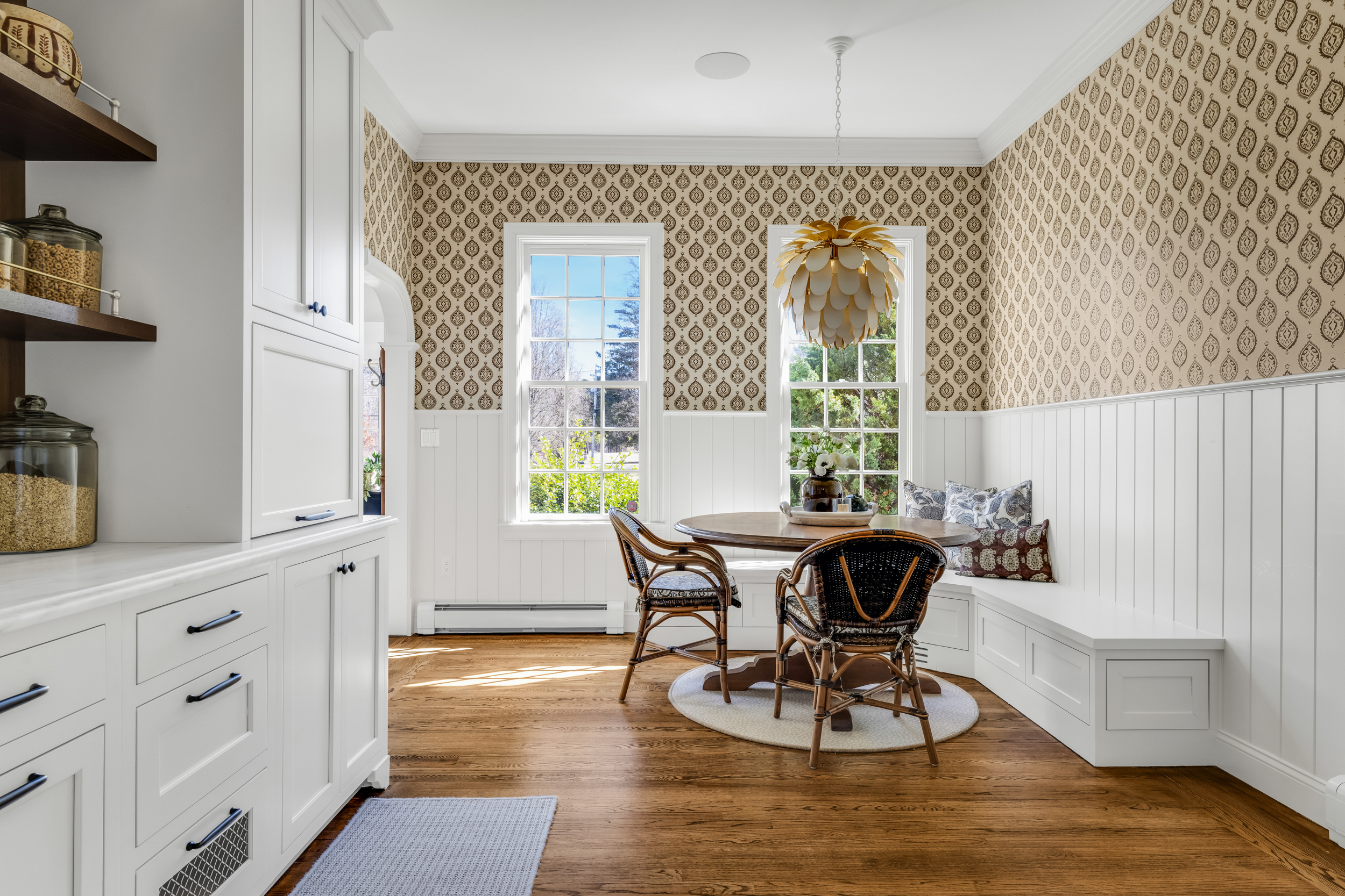 Wide view of the Norwell kitchen with wood island, white perimeter, and brass accents