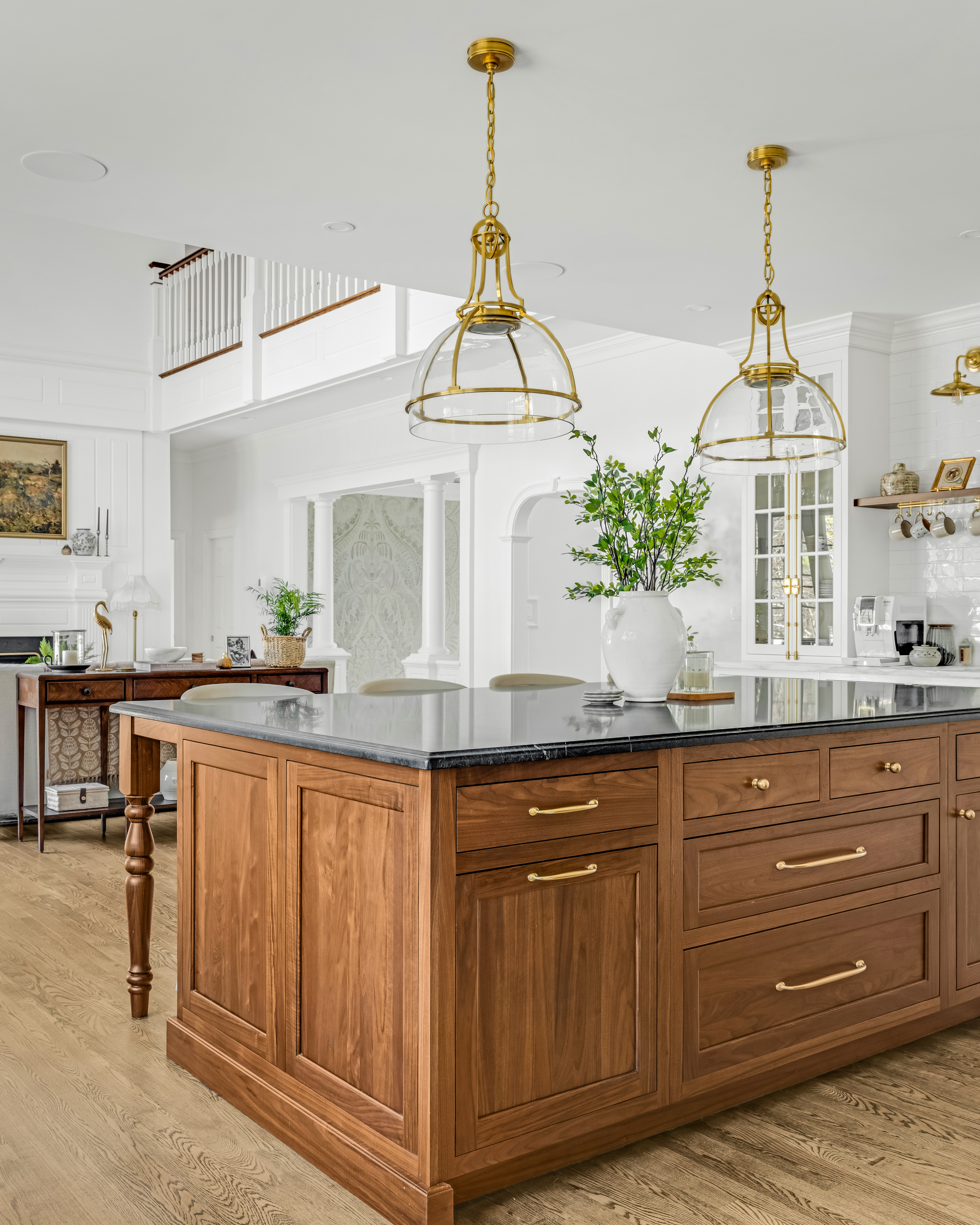 Custom range hood and inset cabinetry on the kitchen cooking wall