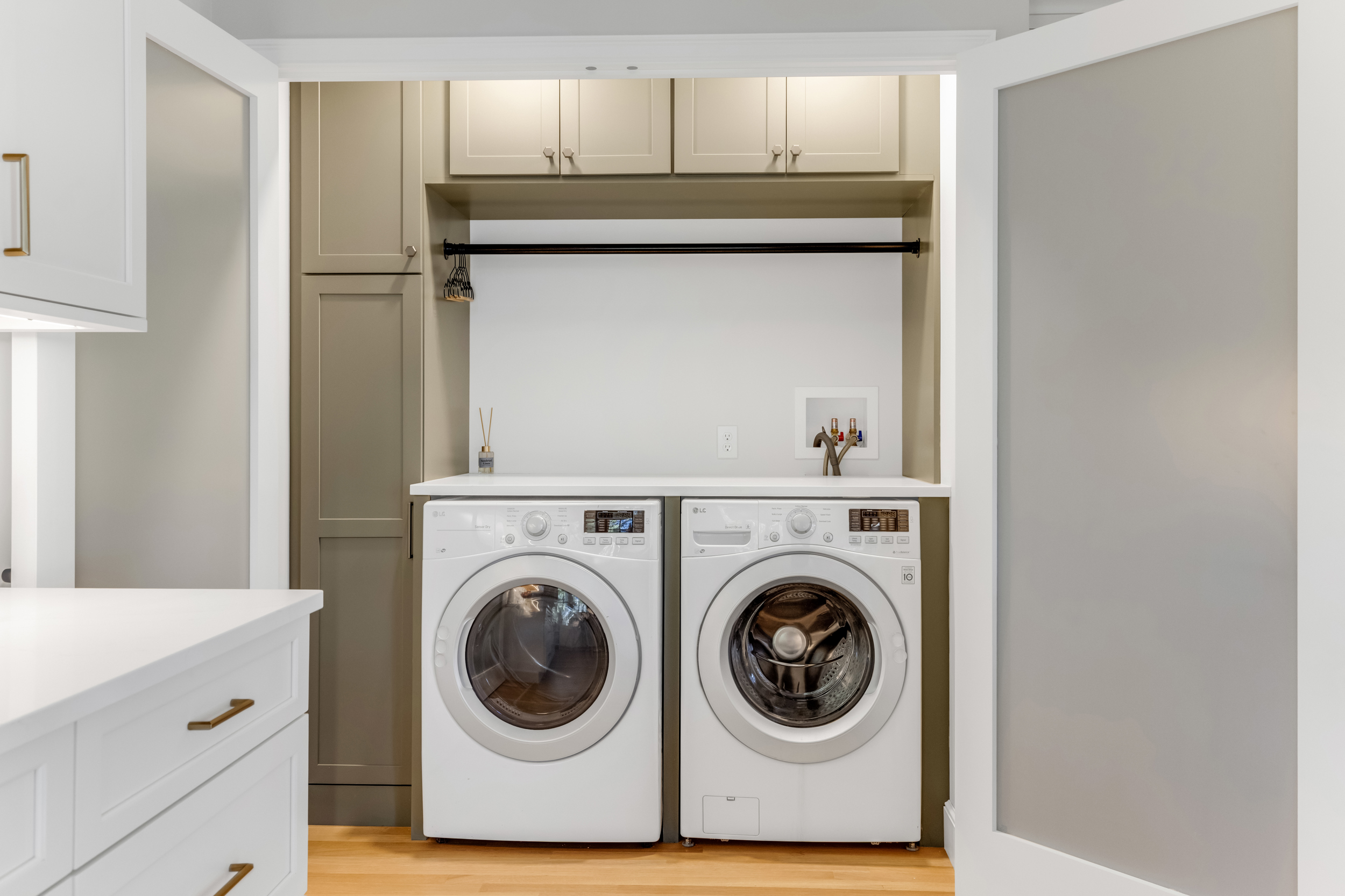 Mouser Divinity laundry cabinetry in Ash Gray with full-height storage