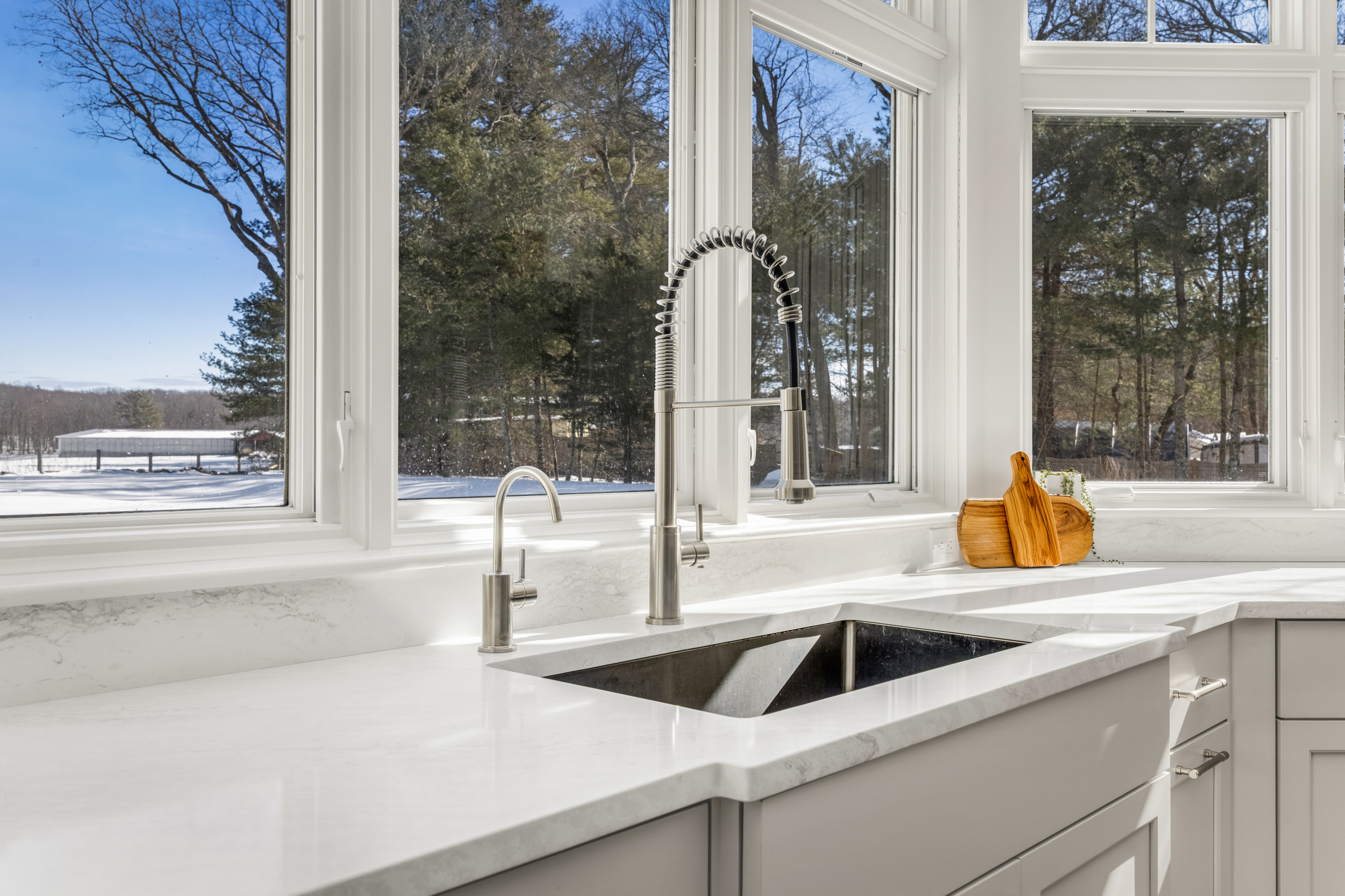 Detail of decorative wire-insert cabinet doors on the navy kitchen island