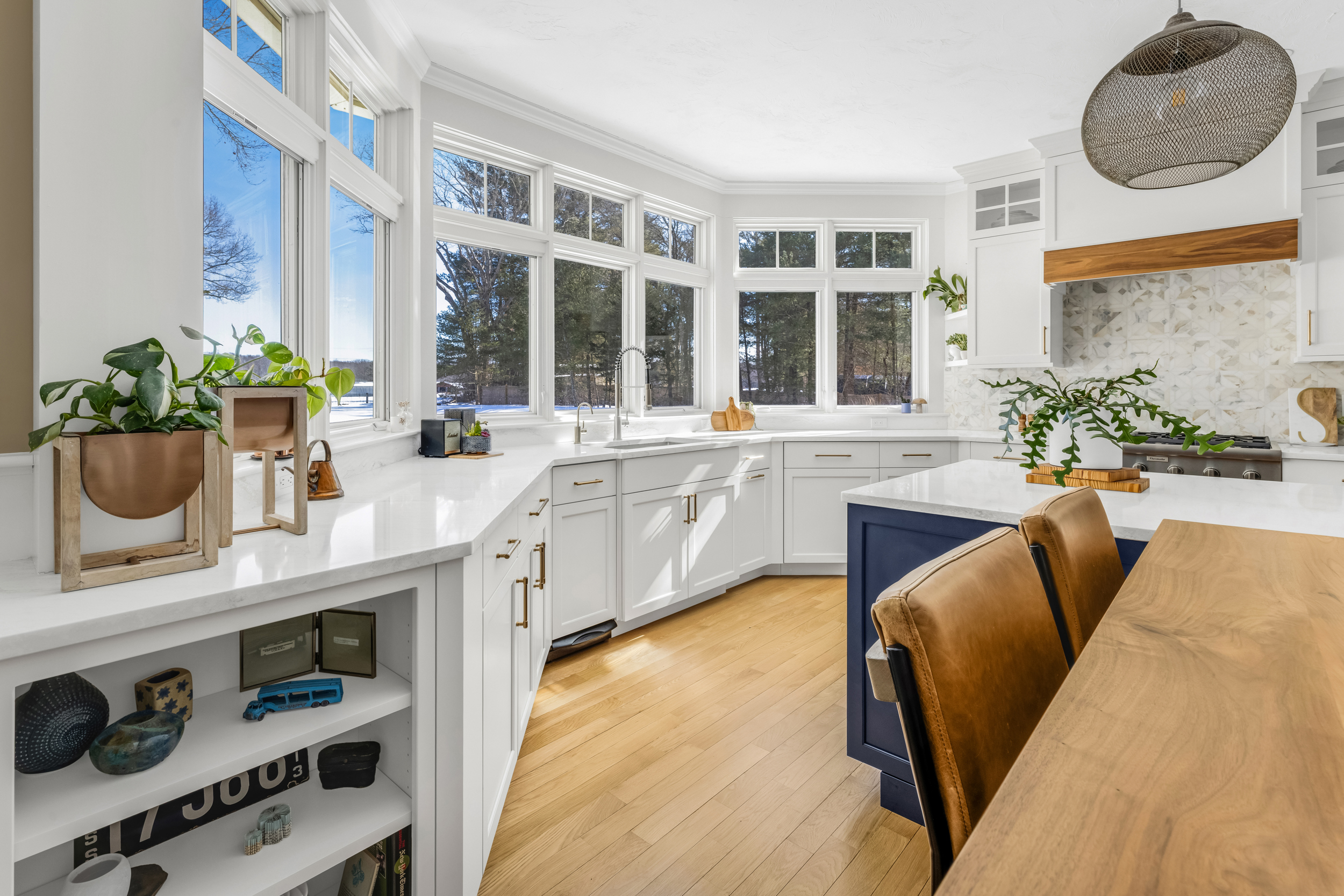 Navy kitchen island with seating and decorative wire-insert cabinet doors