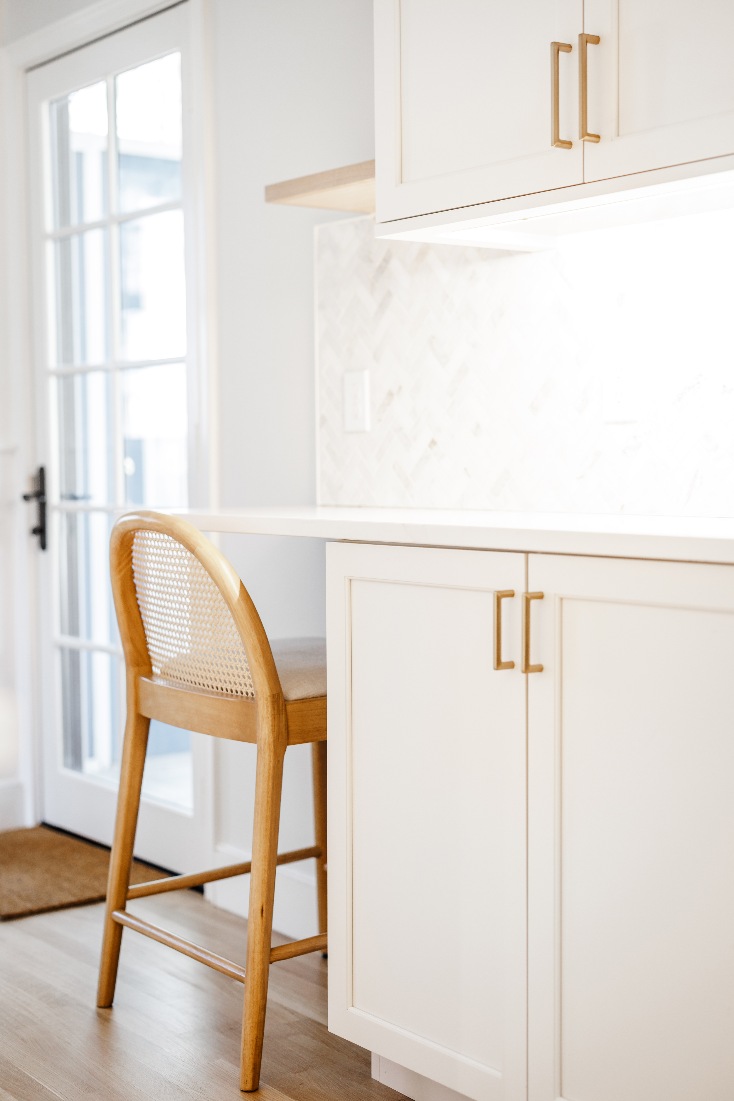 Close-up of the navy island with brass Top Knobs hardware in Honey Bronze