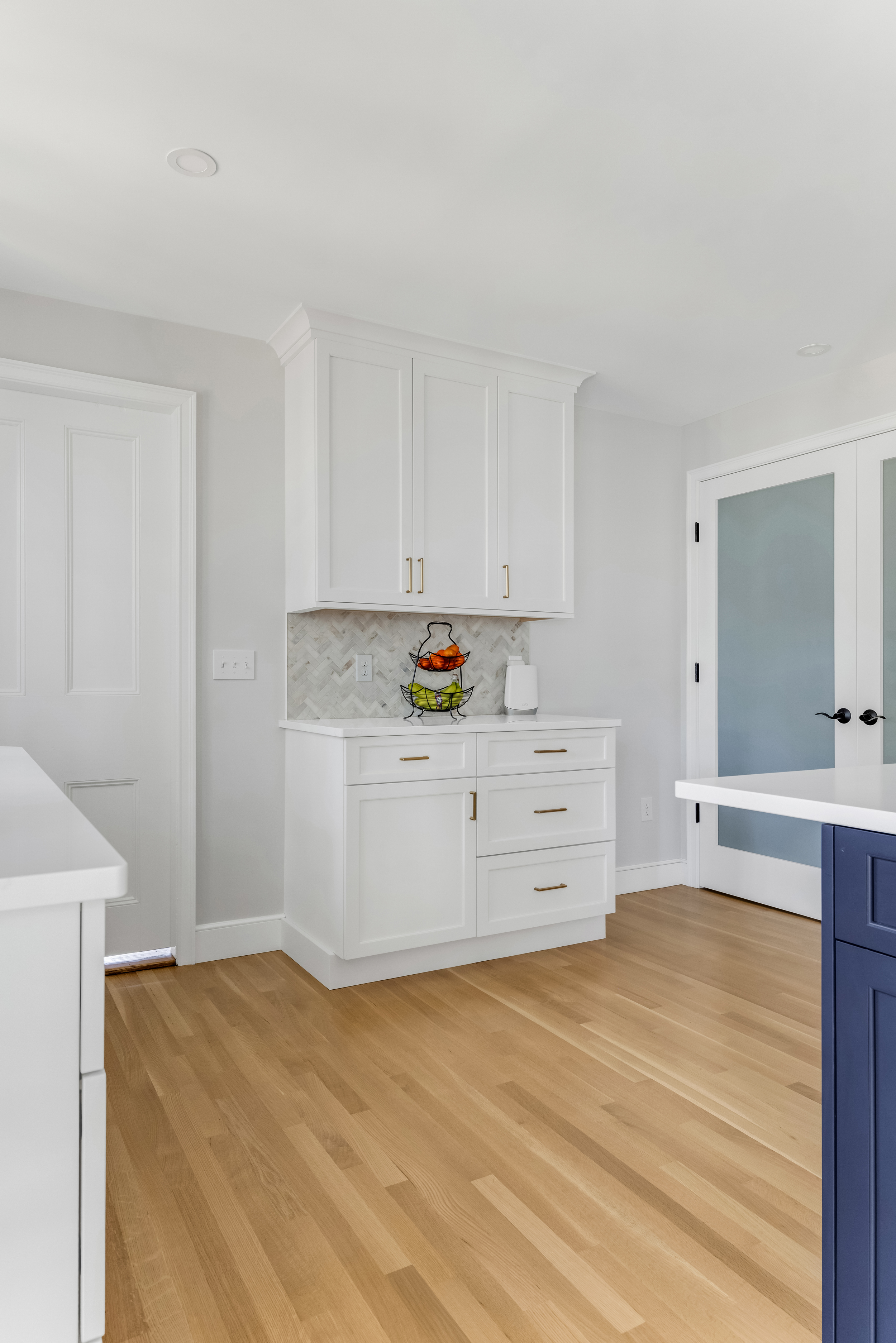 Built-in coffee station with penny round Alaska White marble mosaic backsplash