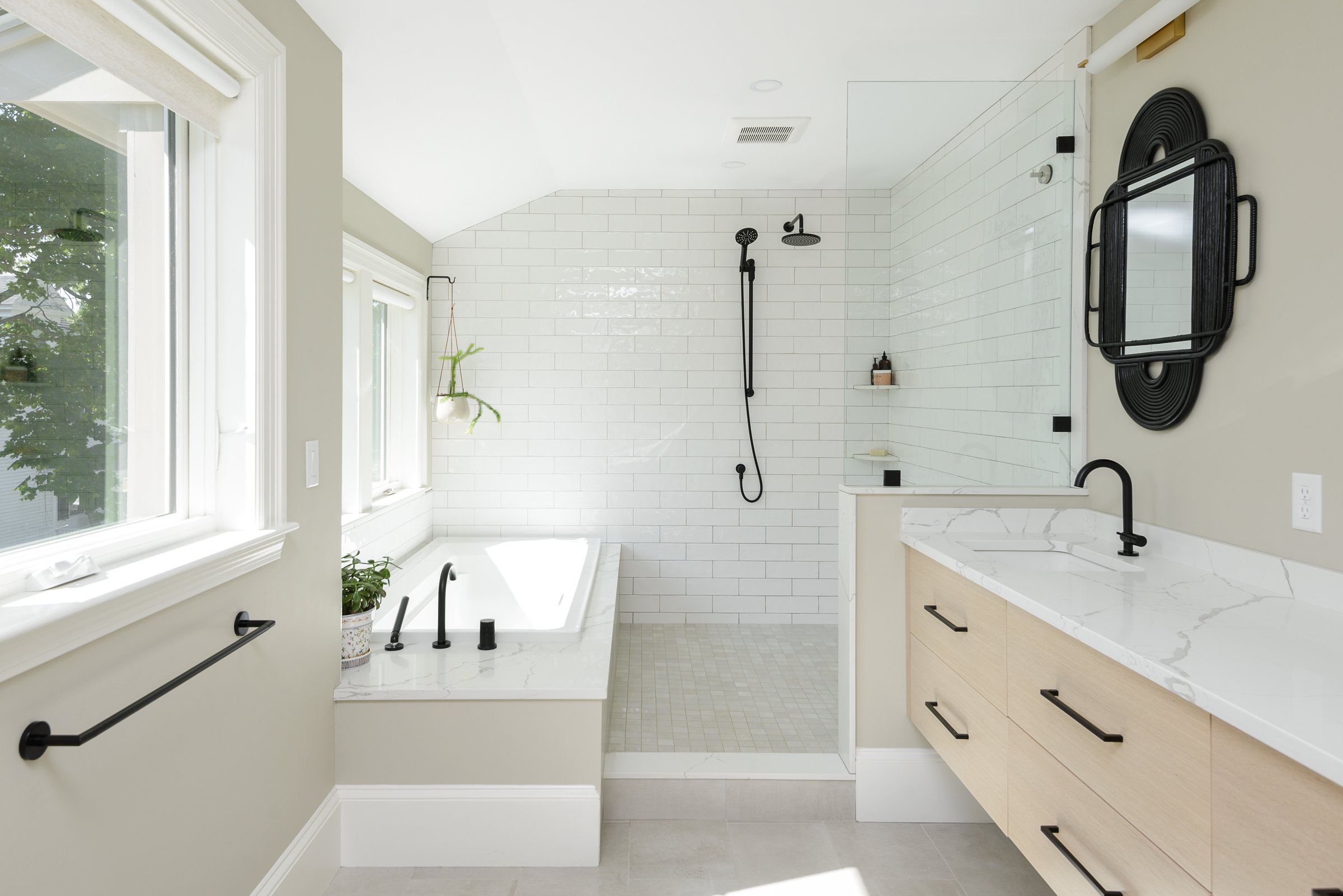 Hingham transitional primary bathroom with twin white oak vanities, corner walk-in shower, and undermount tub.