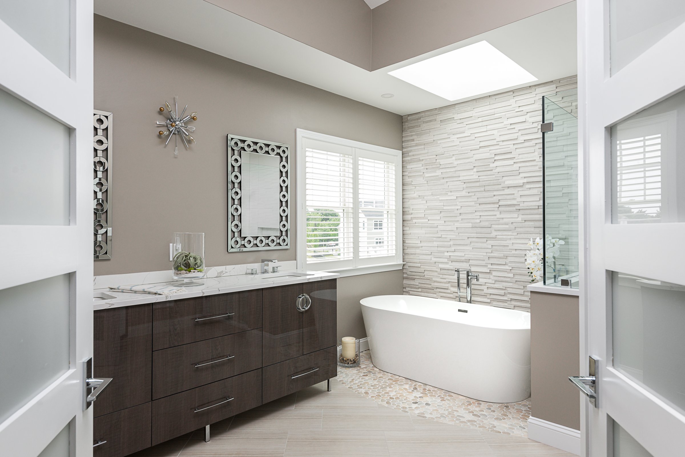 freestanding tub against stacked stone
