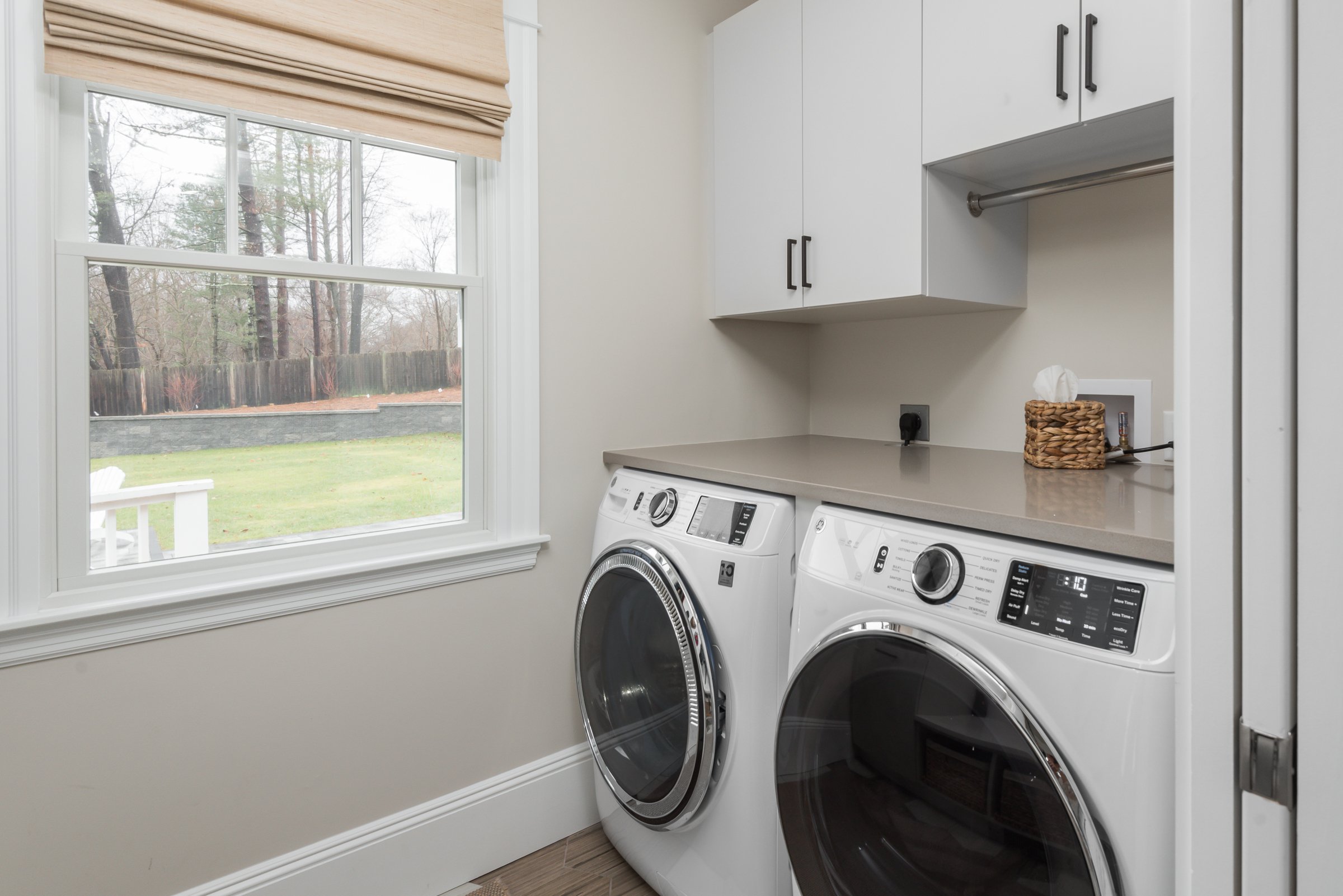 Laundry room with Tedd Wood First Star cabinetry and Portor leather-finish counter