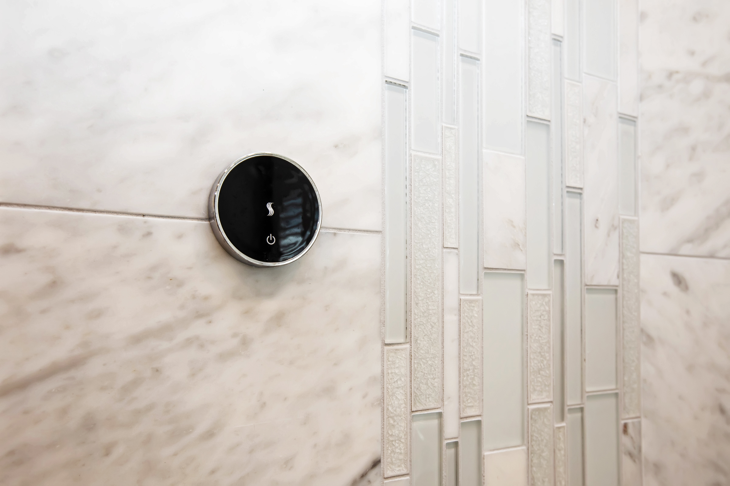 ThermaSol steam control close-up in the Carrara marble shower in the Hingham primary bath