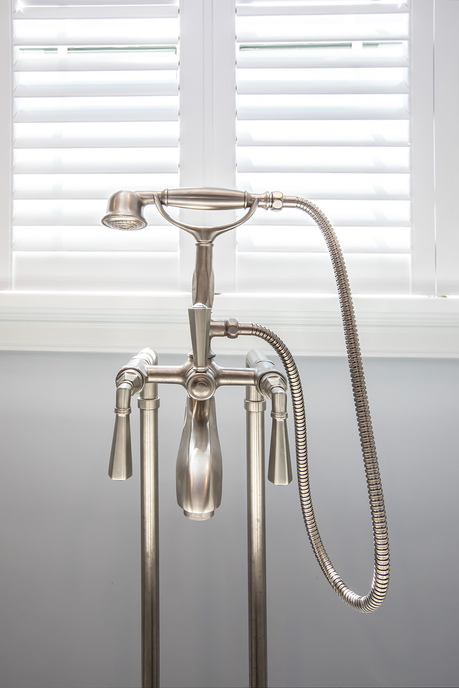 Brushed nickel telephone-style tub filler at the Victoria and Albert freestanding tub in the Hingham primary bath