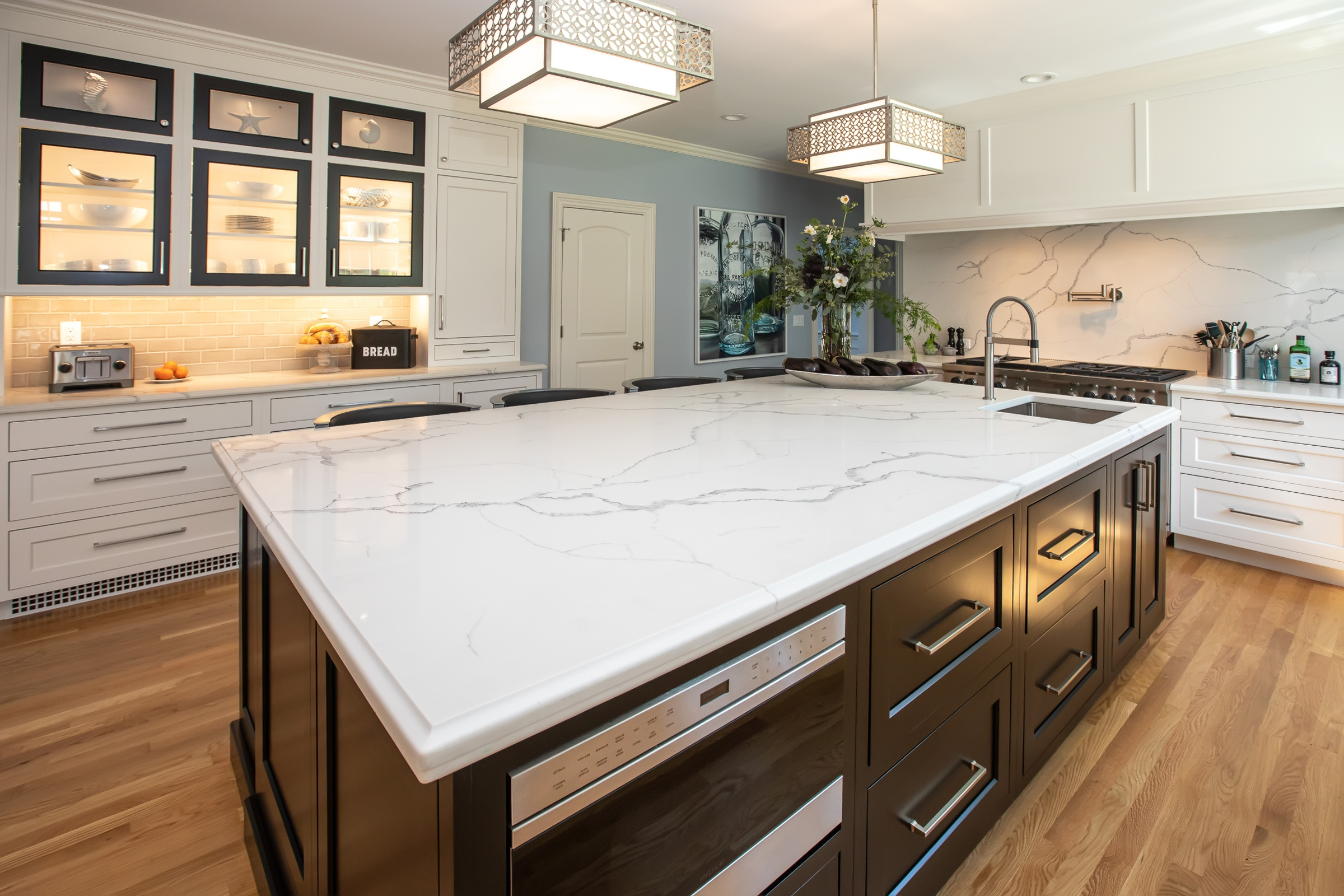 Dark wood Mouser kitchen island with built-in microwave and engineered quartz countertop in Hingham