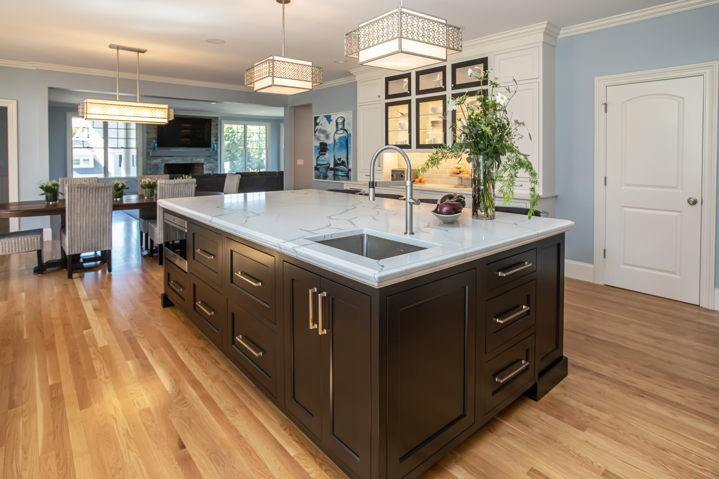 Dark wood beaded inset island with satin nickel hardware in the Hingham kitchen
