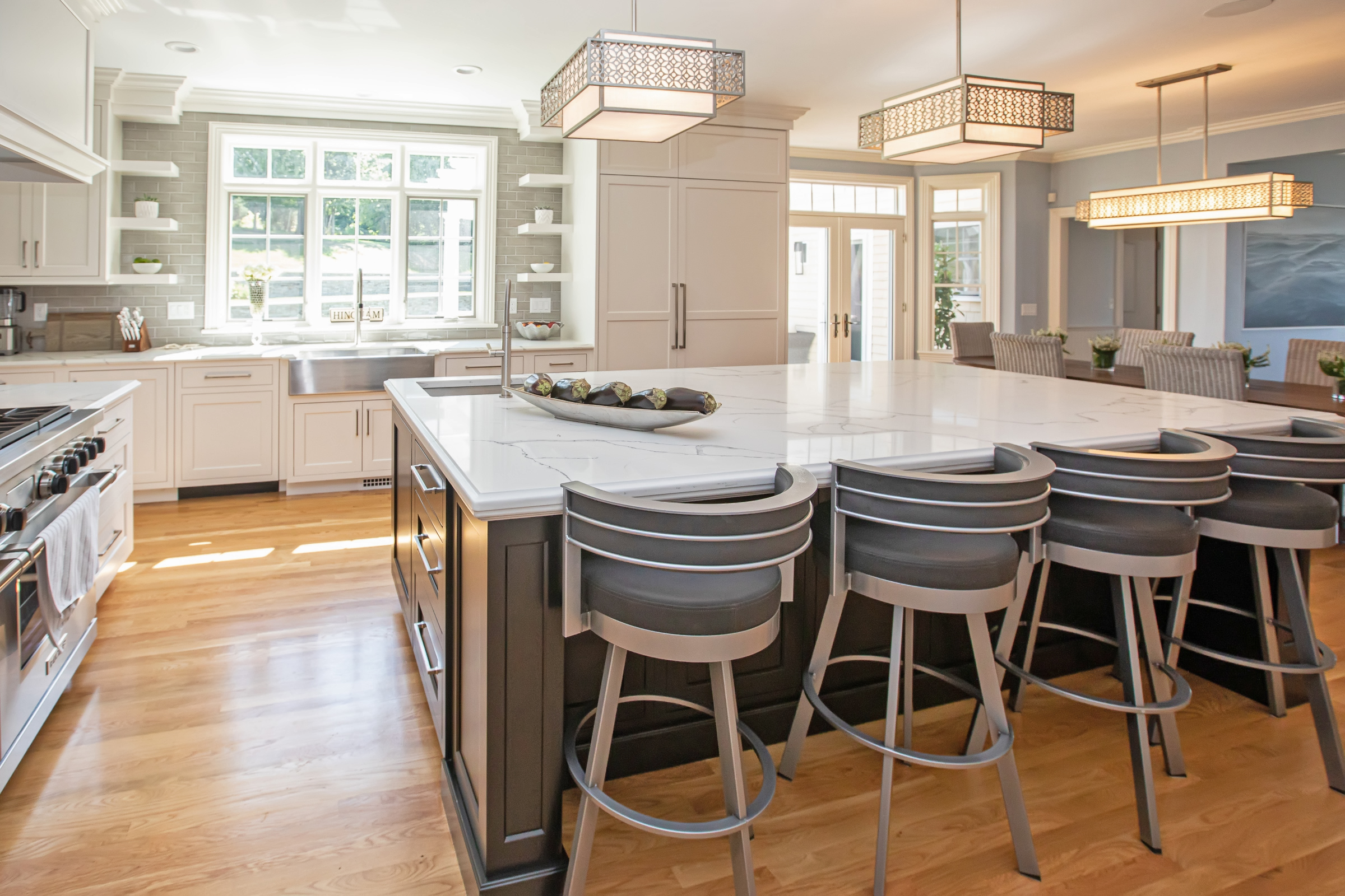 Kitchen island detail with engineered quartz counter and Feiss Kenney pendant lights in Hingham