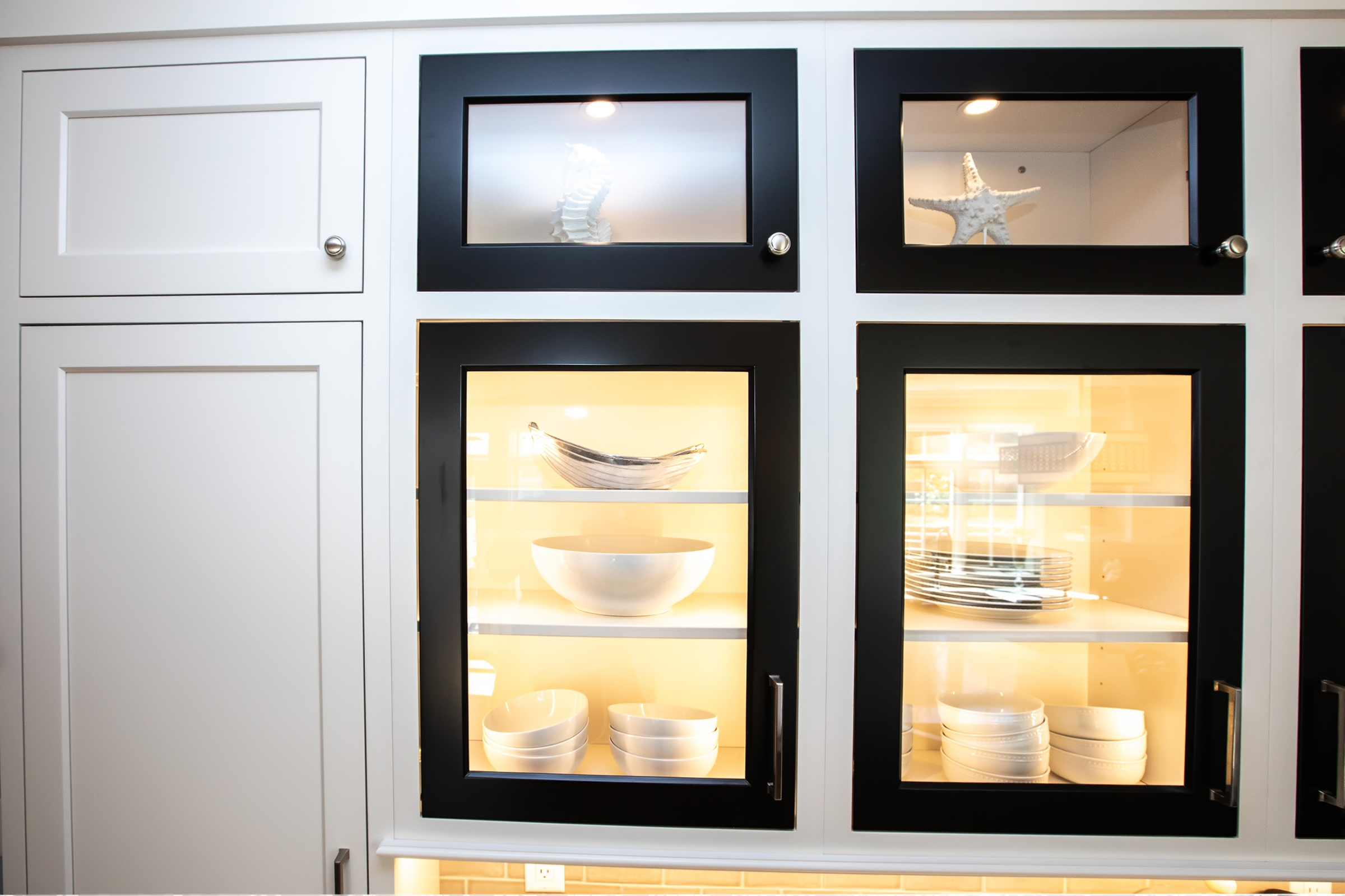 Black-frame glass-front display hutch in the Hingham kitchen