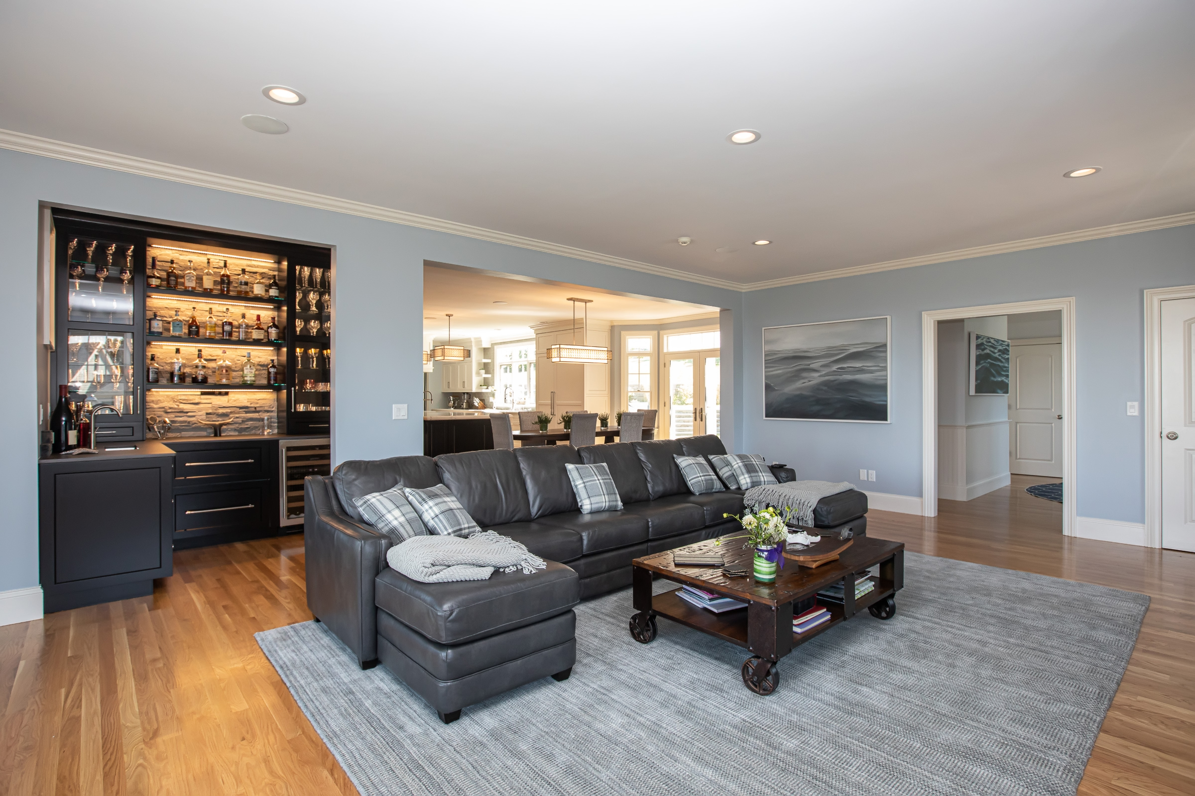 Open living room beside the Hingham kitchen with refreshed fireplace mantel