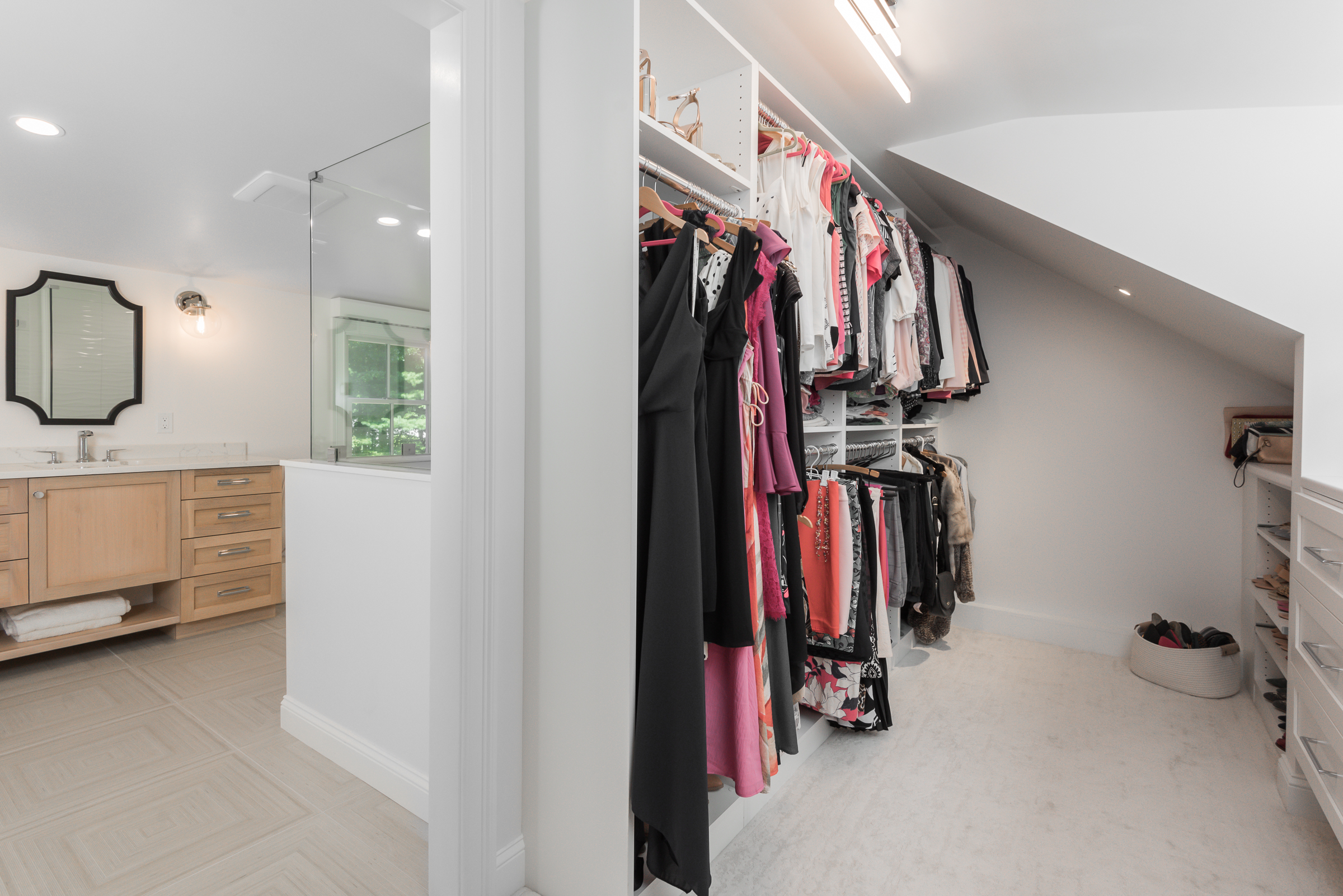 Walk-in closet with custom Plus Closet system adjoining the Norwell primary bath