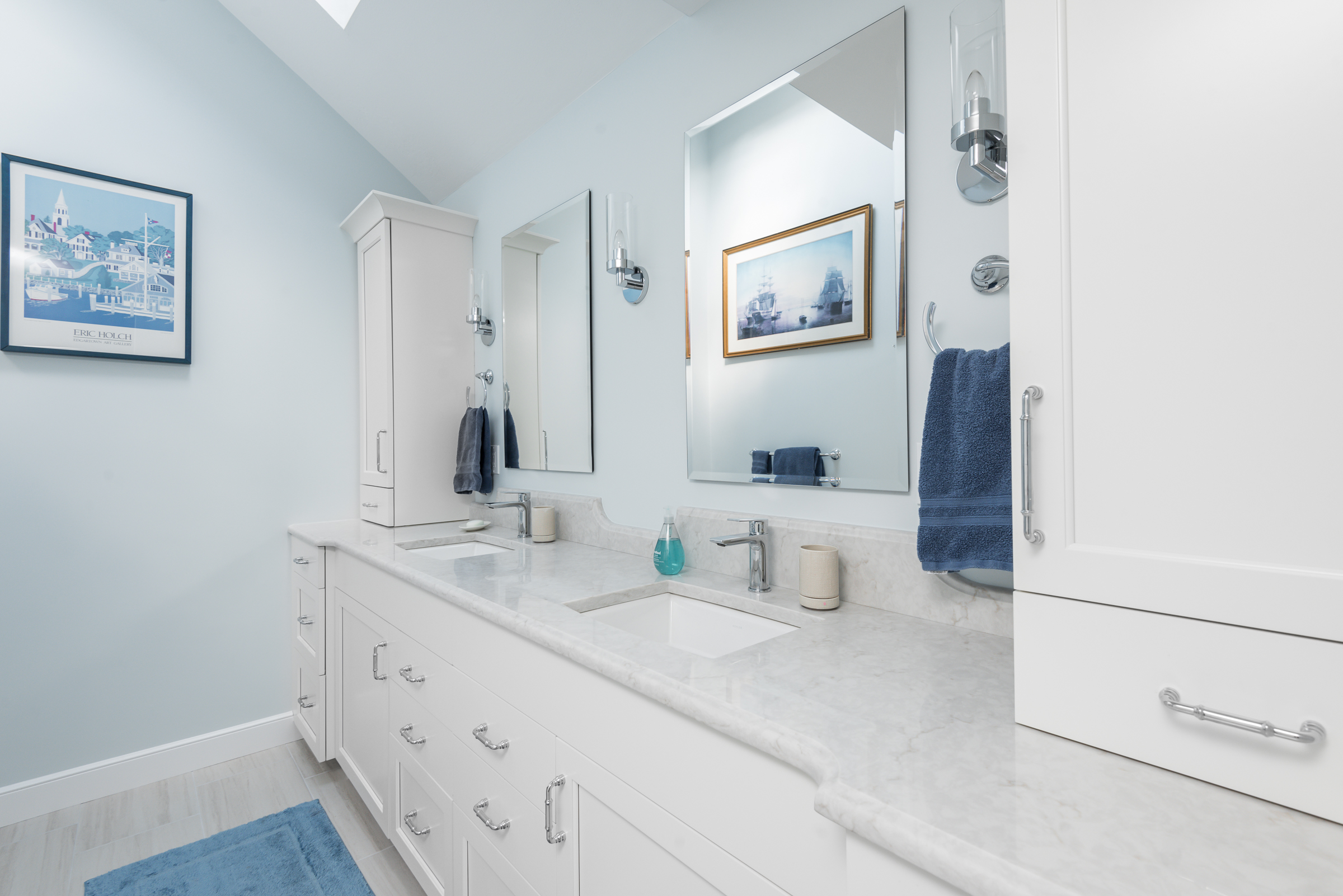 Hingham coastal primary bath with white Tedd Wood double vanity, skylight, and harbor art