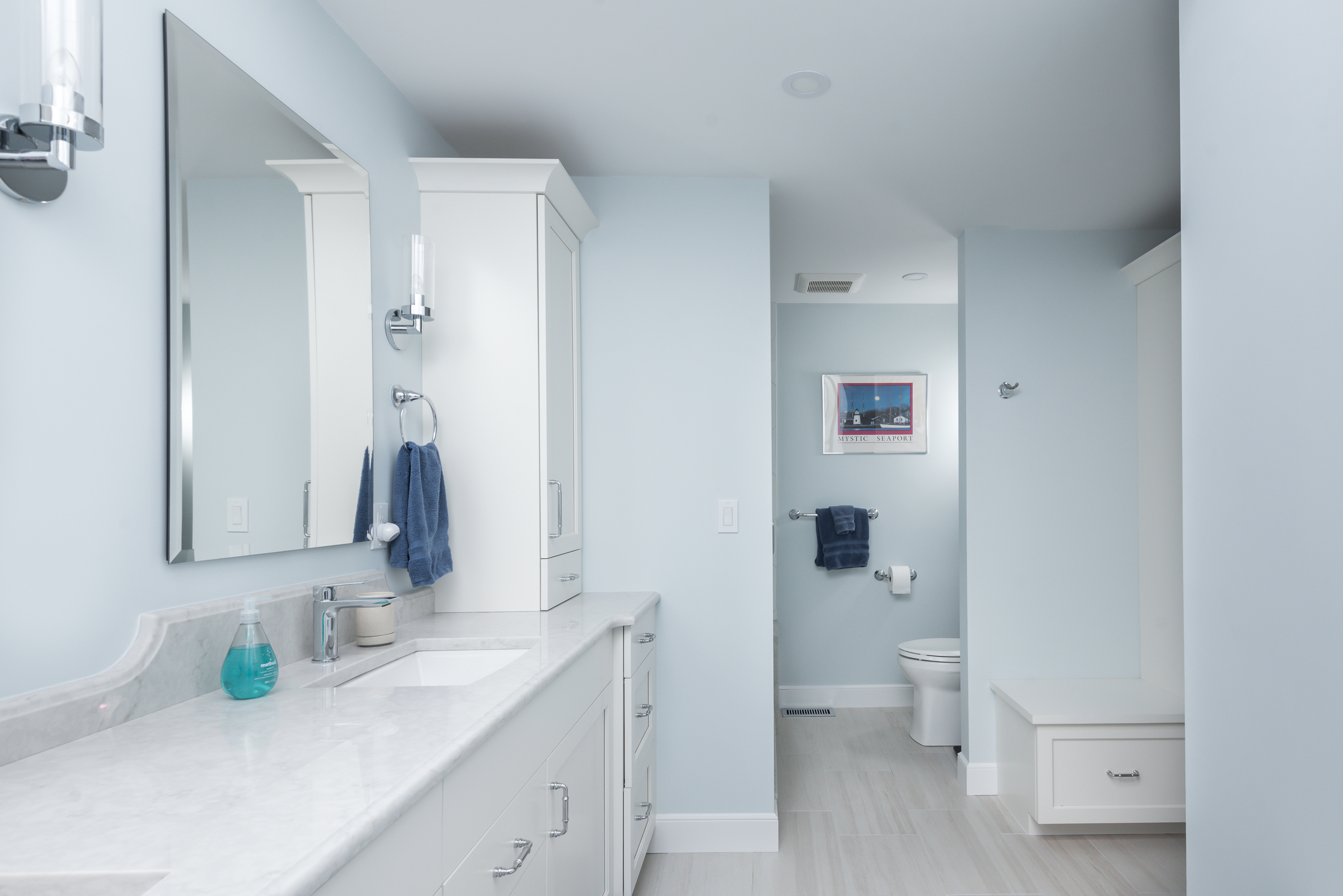  White picket tile shower with marble hex niche and built-in seat in the Hingham coastal primary bath
