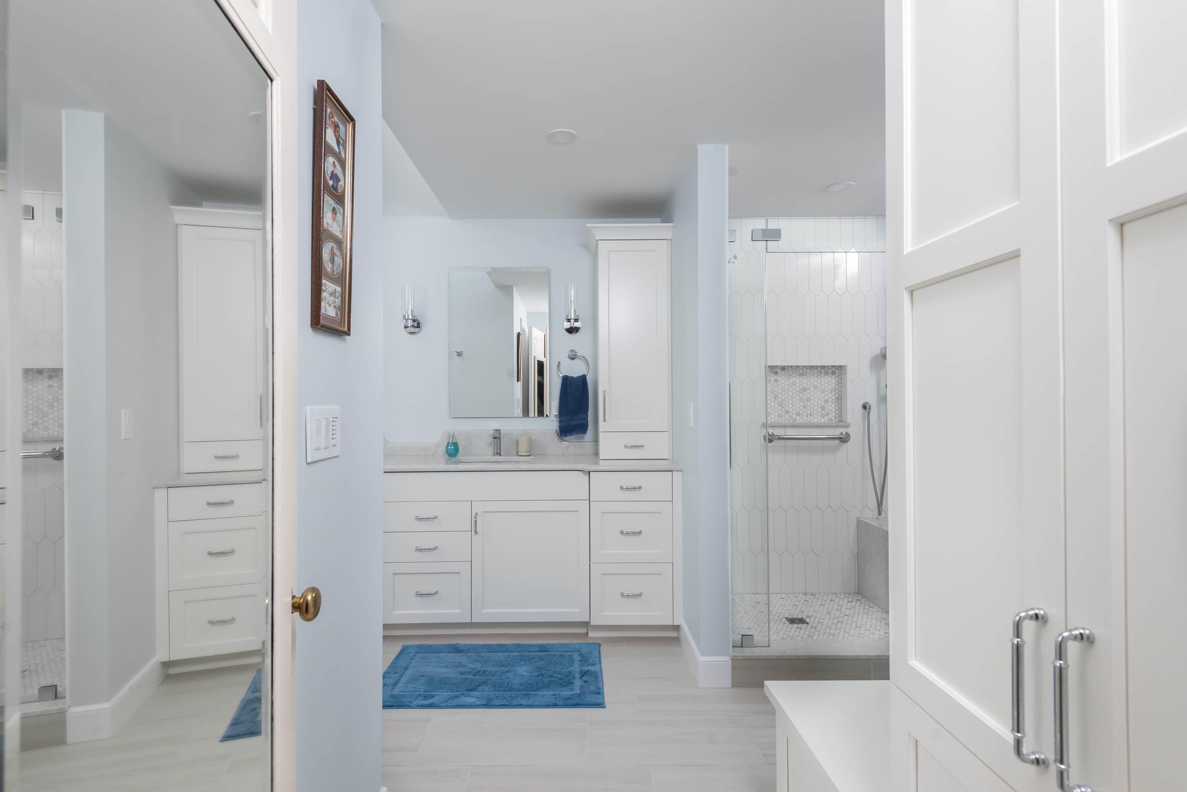 White Tedd Wood vanity with chrome hardware and sconces in the Hingham coastal primary bath