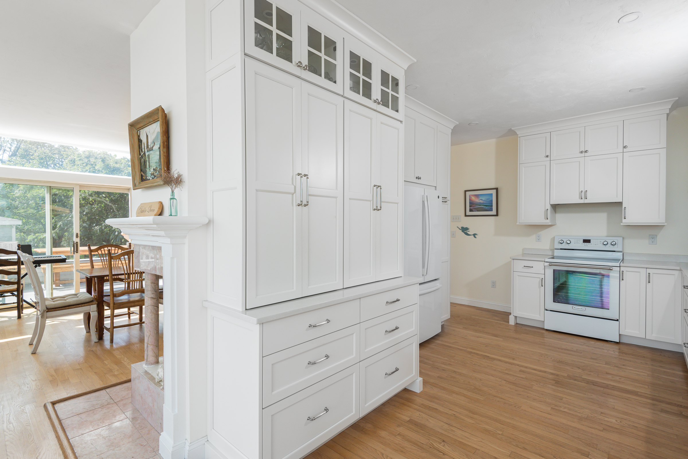 Floor-to-ceiling pantry and panel-front fridge surround with water view in the Scituate kitchen