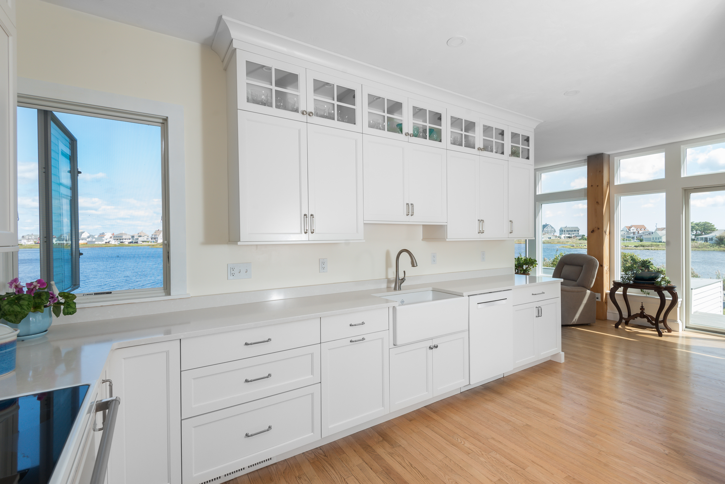 Scituate coastal kitchen with white Mouser cabinetry and waterfront views through the windows