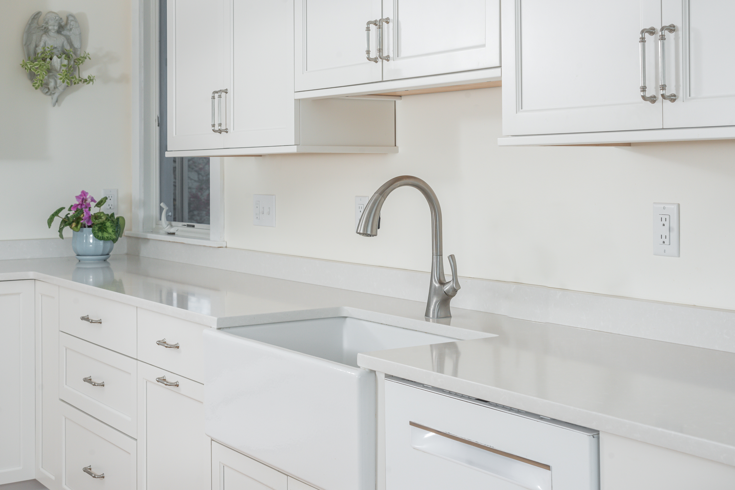 Fireclay farmhouse sink with brushed nickel faucet detail in the Scituate coastal kitchen