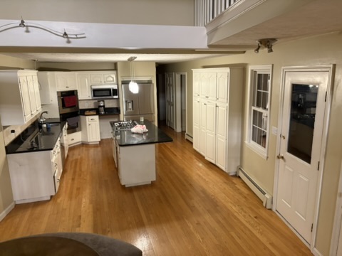 Original Hingham kitchen before remodel showing the side door entry where the new mudroom addition was built