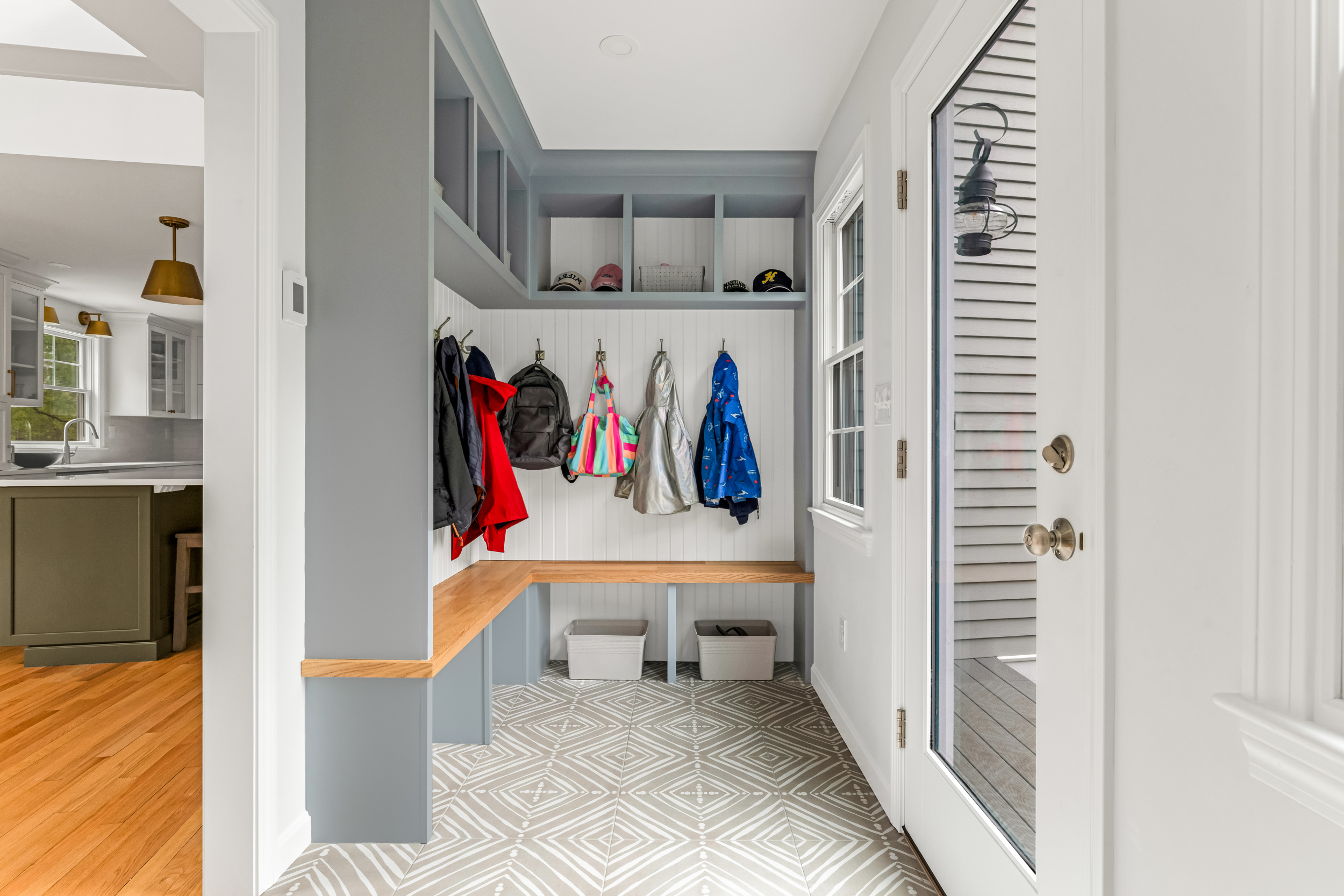 Mudroom entry leading into the kitchen with patterned tile floor