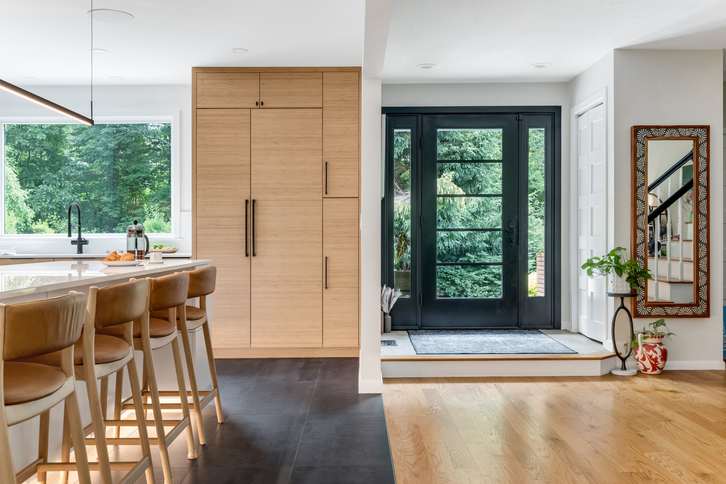  New black-framed glass front entry door with oak flooring in a Marshfield home remodel
