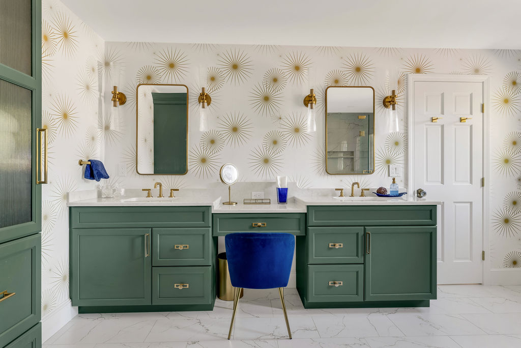 Emerald green double vanity with a cobalt velvet stool and gold sconces in a Hingham primary bath