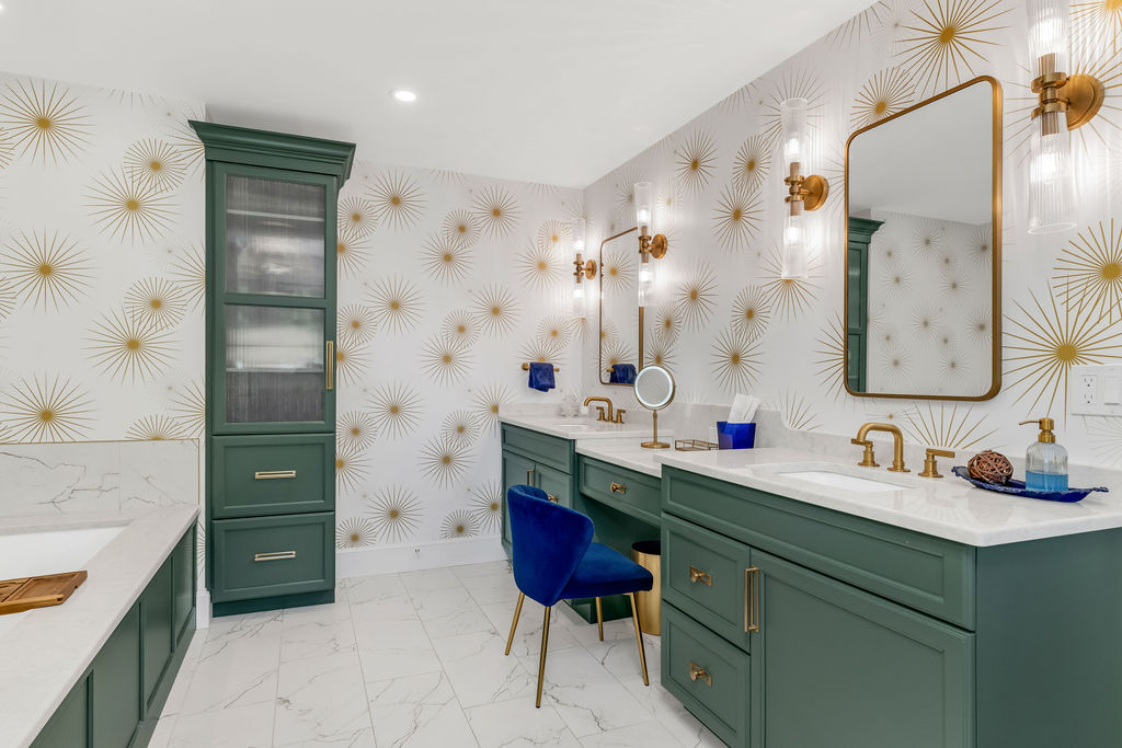 Green Mouser vanities and makeup station with brass sconces and gold starburst wallpaper in a Hingham primary bath
