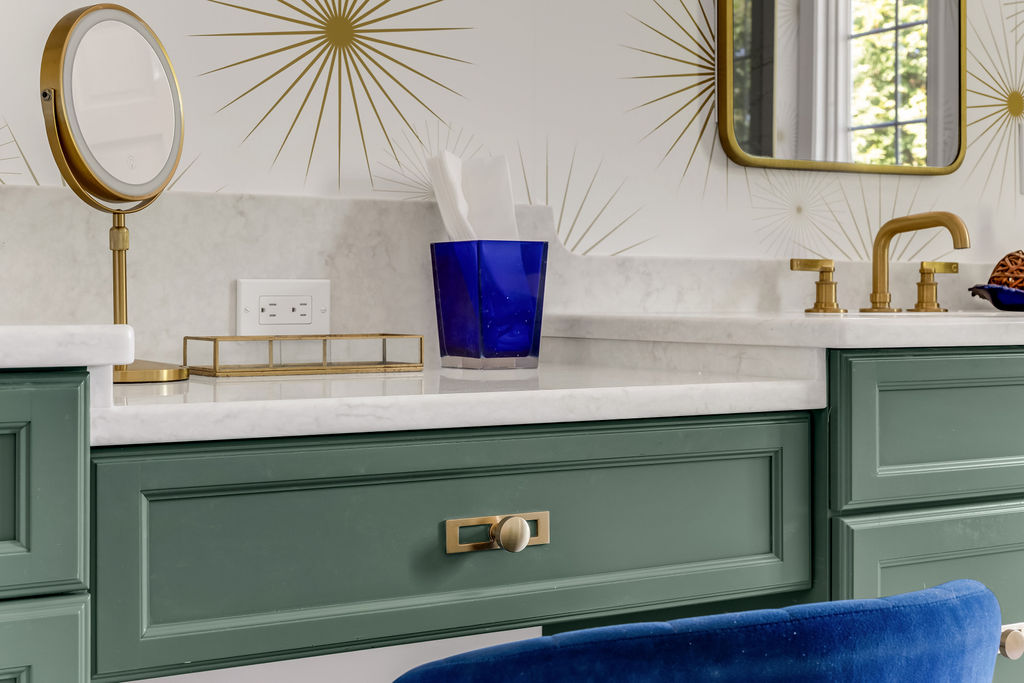 Green vanity drawer detail with brushed brass hardware and quartz counter in a Hingham primary bath
