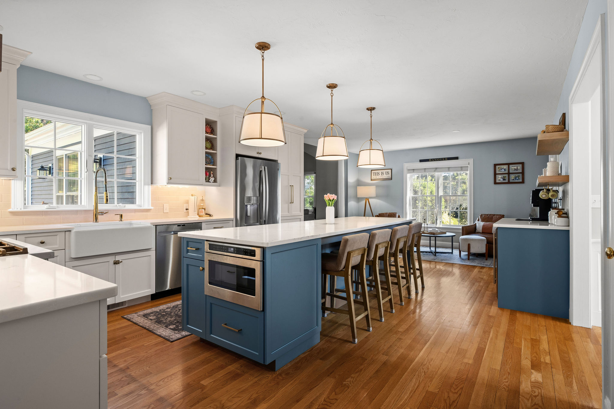 Hanover kitchen with a Seaglass island, farmhouse sink, and built-in microwave open to the living room