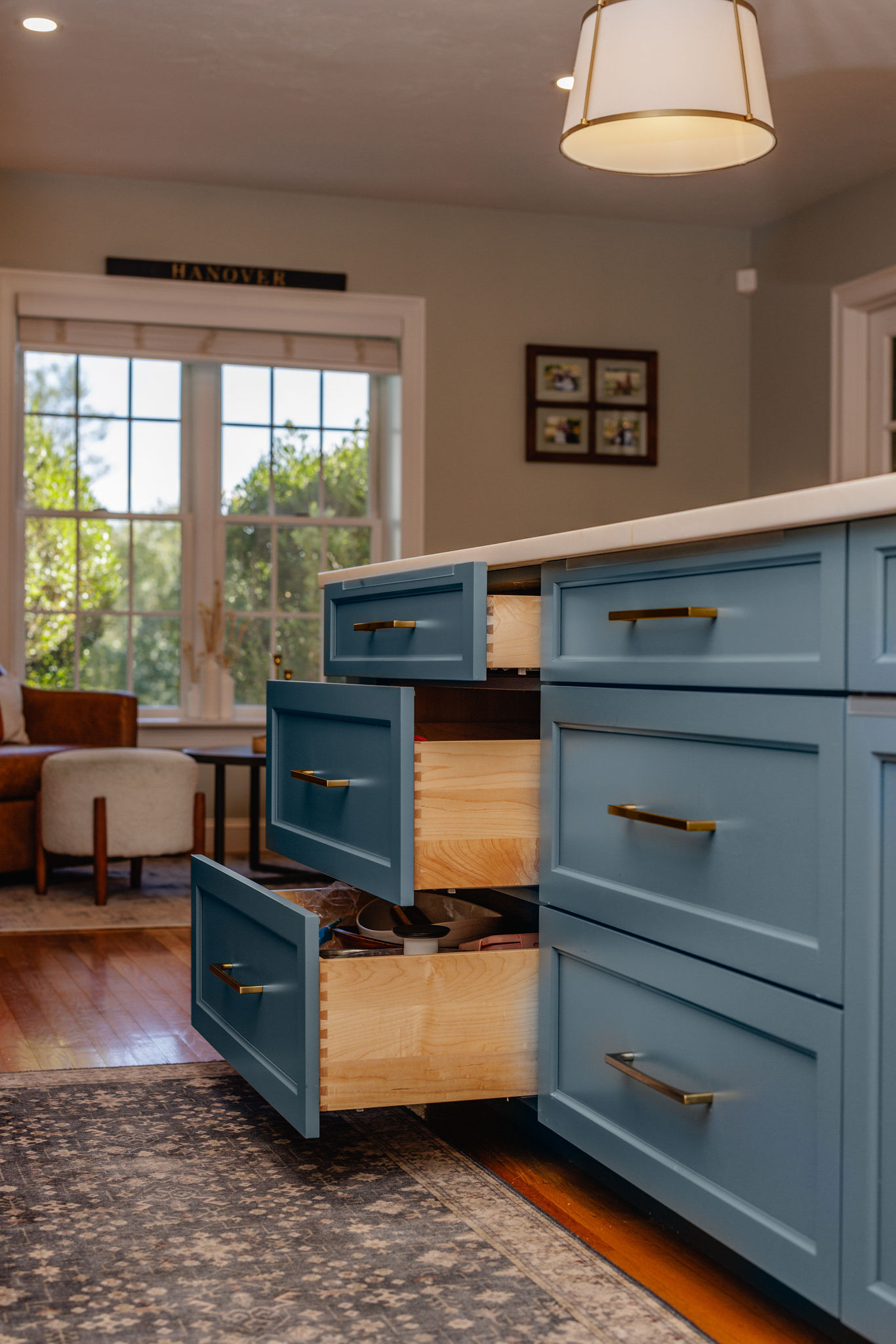 Seaglass island drawers with brass hardware and dovetailed wood boxes in a Hanover kitchen