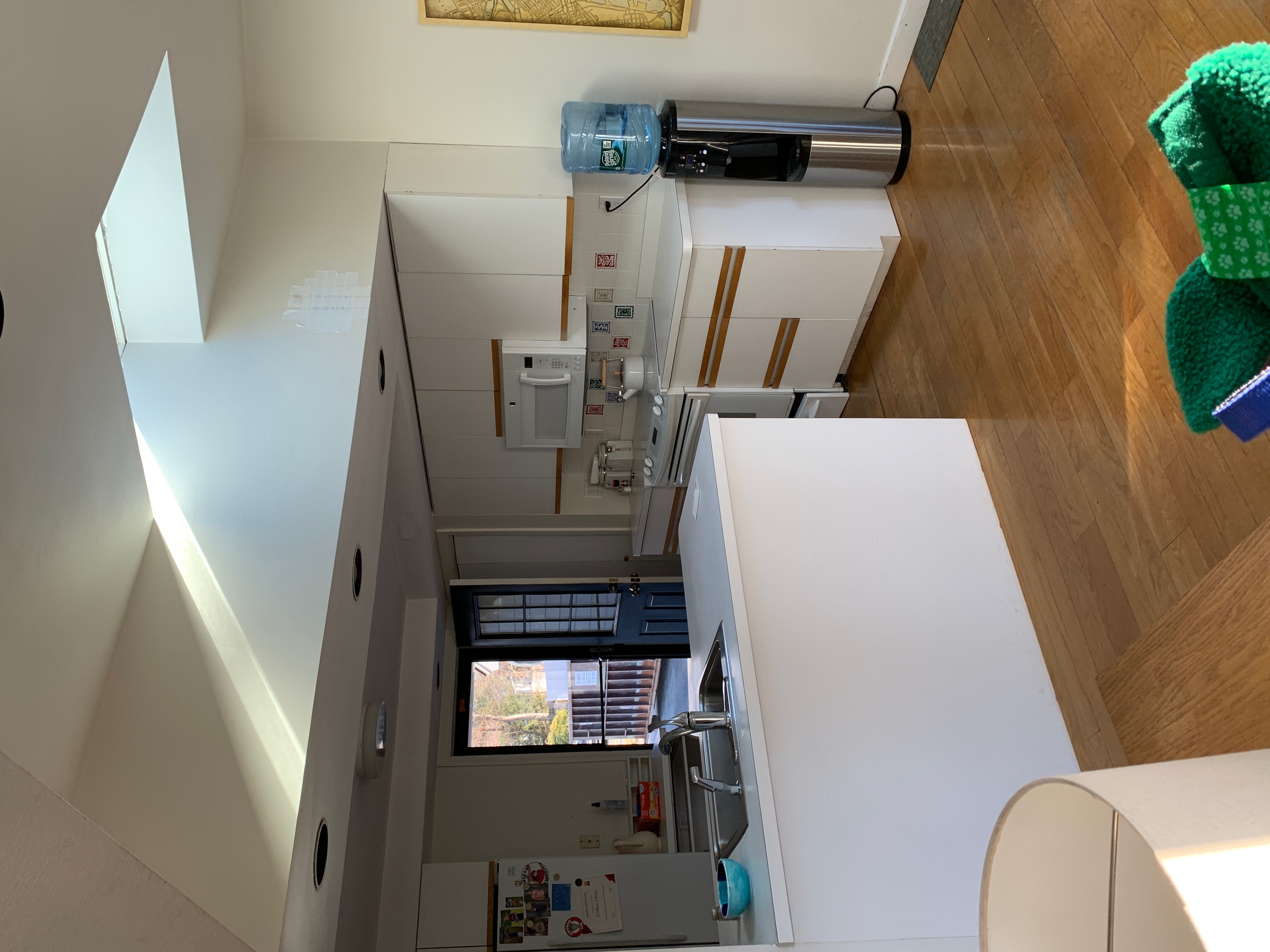 Before renovation: the original Hingham kitchen peninsula and dated cabinetry before the remodel