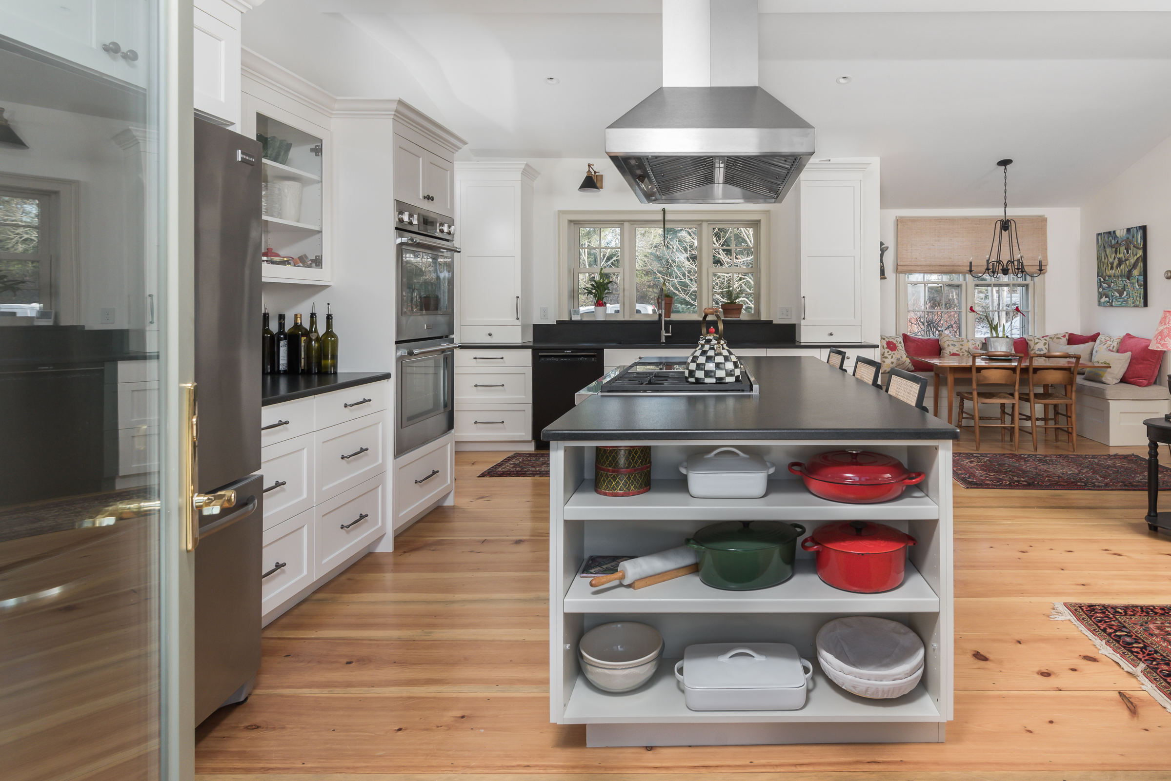 Island open shelving with cookware in a painted shaker Duxbury kitchen
