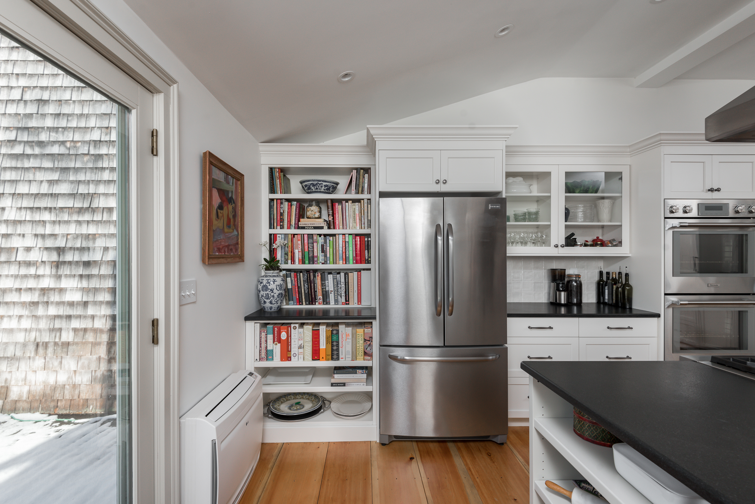Wide pine floors and white shaker cabinetry in a Duxbury kitchen remodel