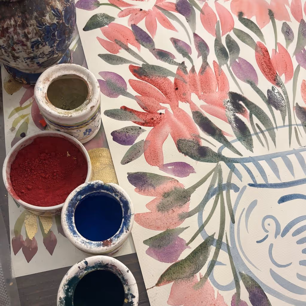 Medio floral painting alongside bowls of natural pigments used to make it.