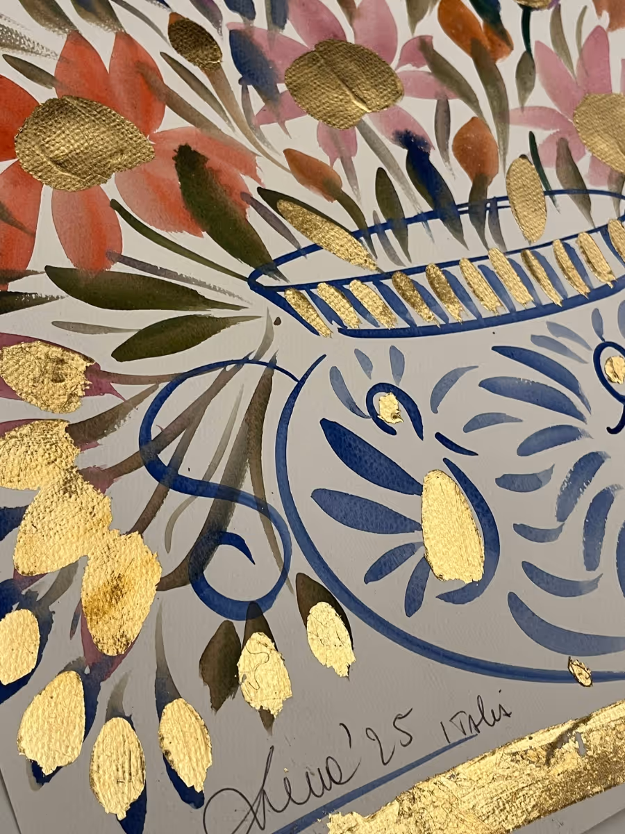 Close-up of floral brushwork in a ceramic vase with blue pattern.