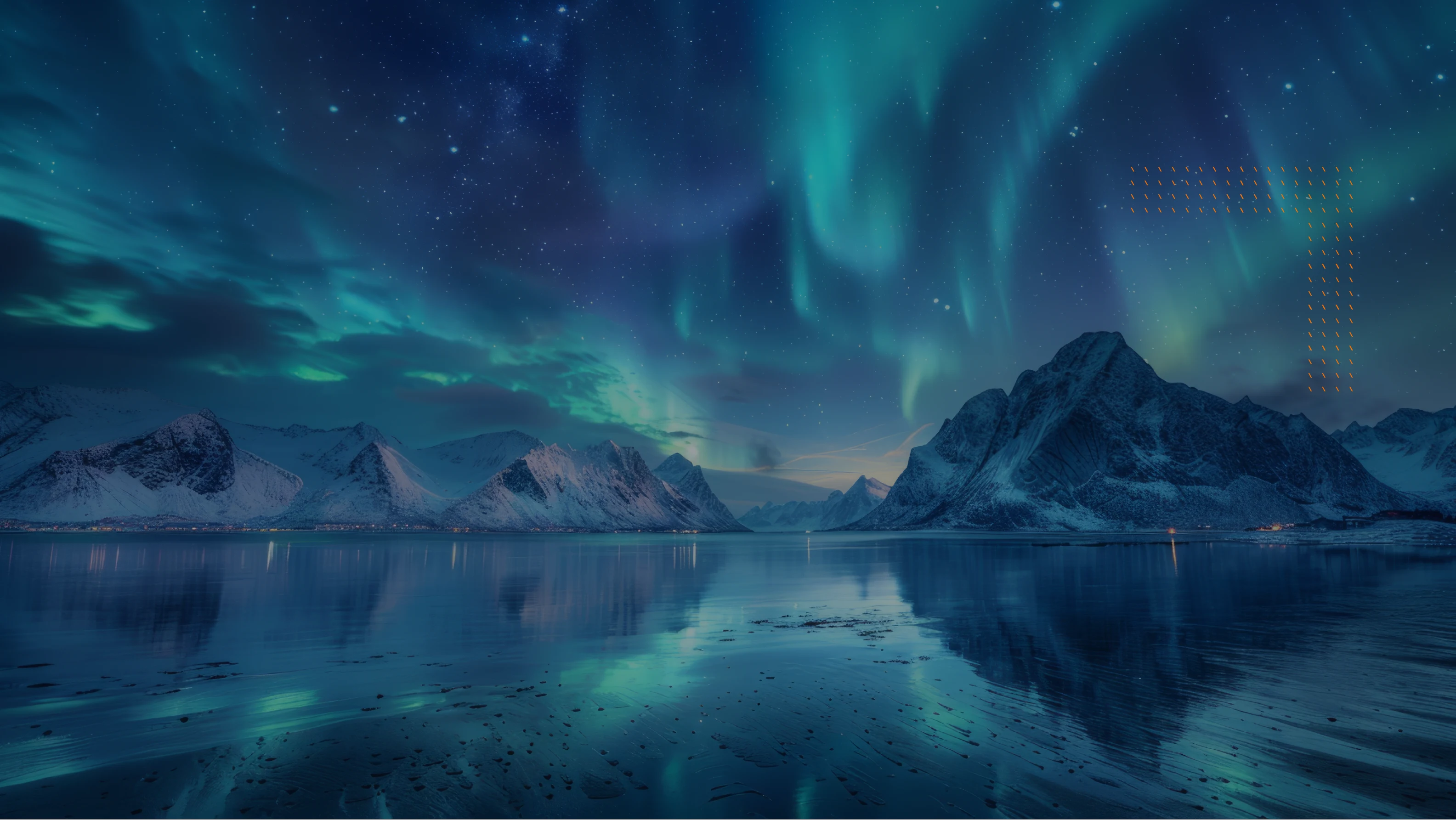 Northern lights glowing over snow-covered mountains reflected in a calm body of water under a starry sky.