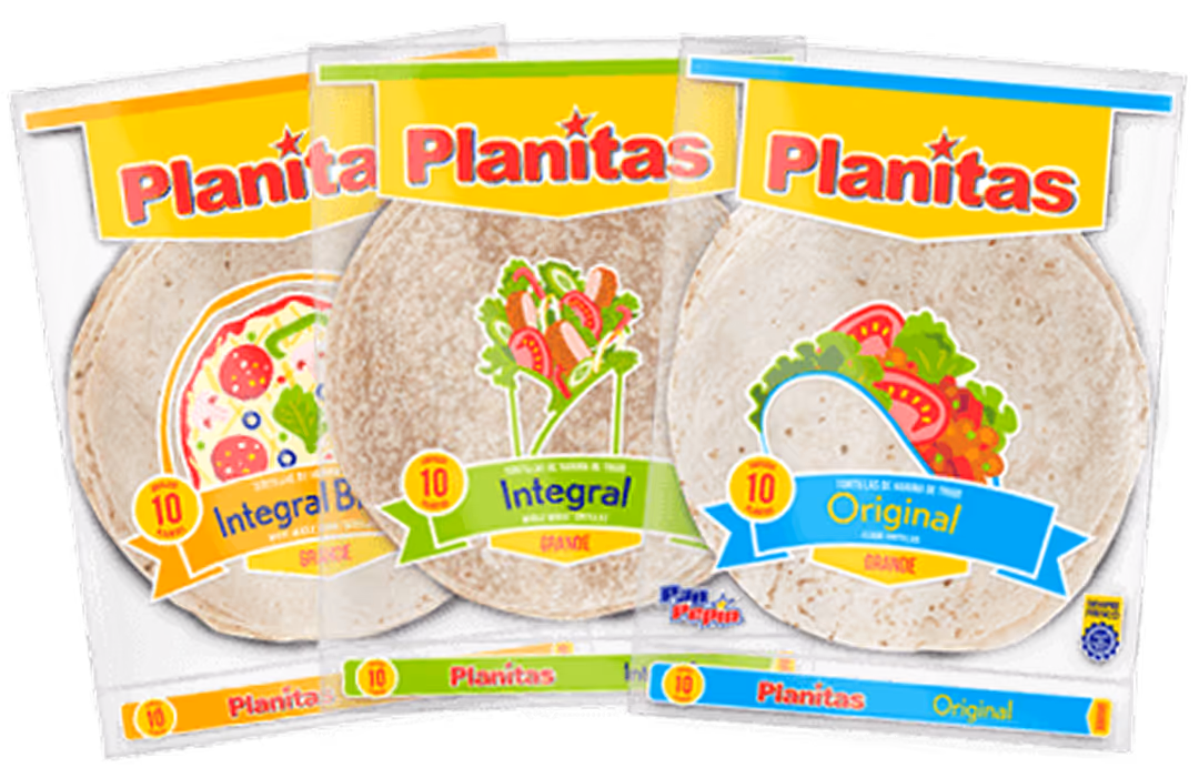 Three packages of Planitas tortillas in orange, green, and blue labels for Integral Blend, Integral, and Original varieties.