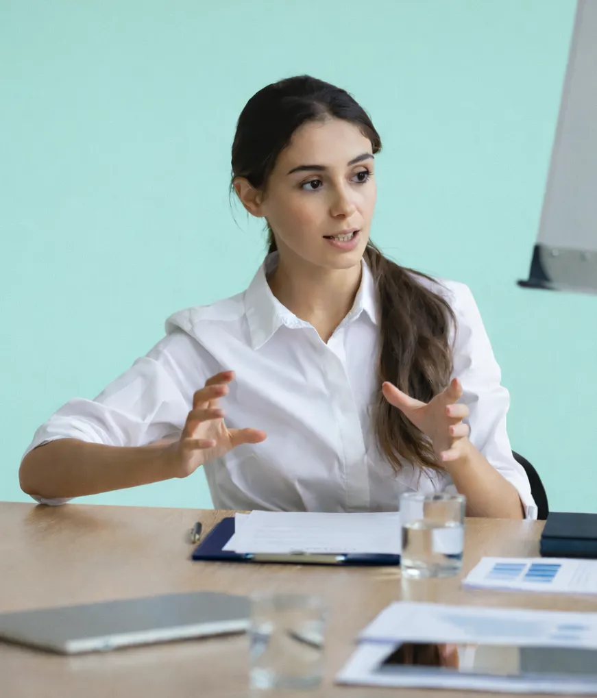 Woman speaking at a meeting table