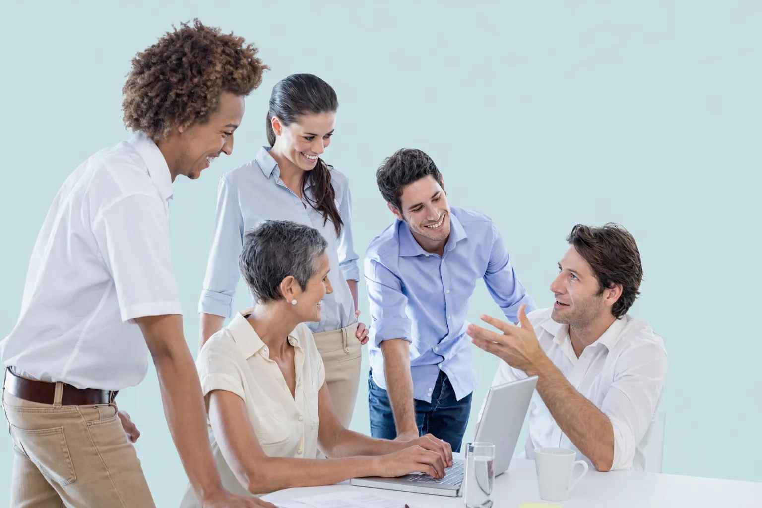 Group working together around laptops
