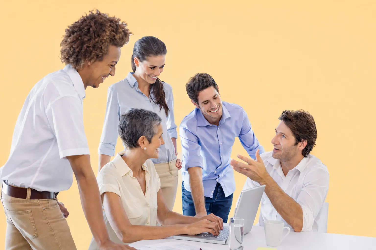 Team in discussion around laptops