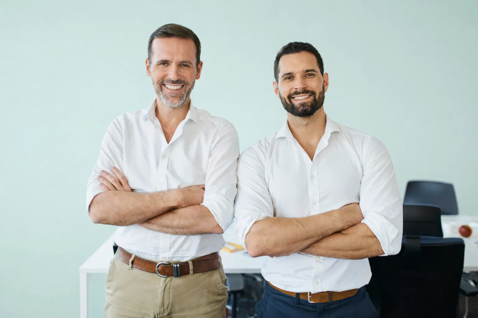 Two founders standing side by side, arms folded
